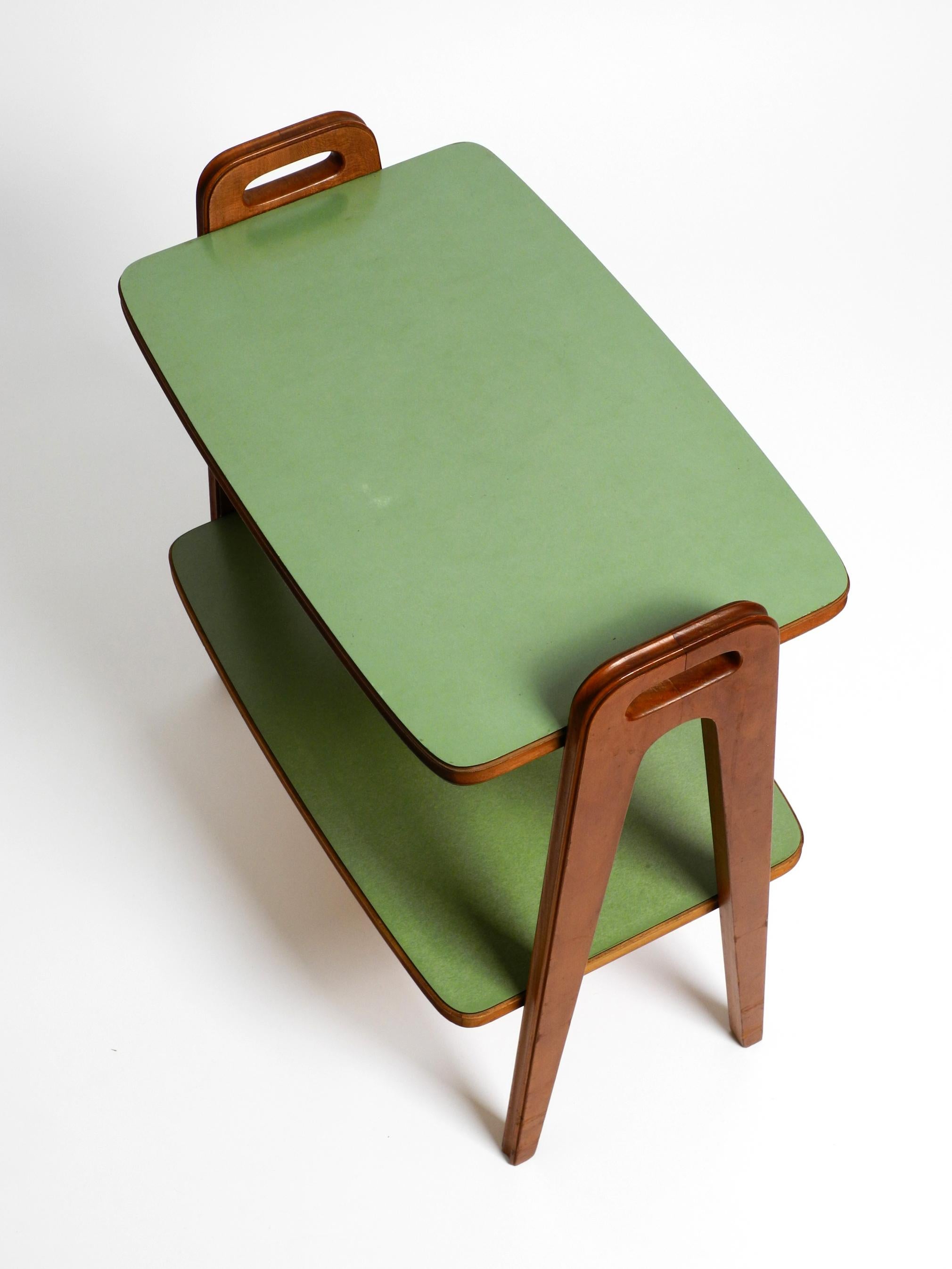 German Small Mid Century Modern side table made of walnut with green Formica surfaces