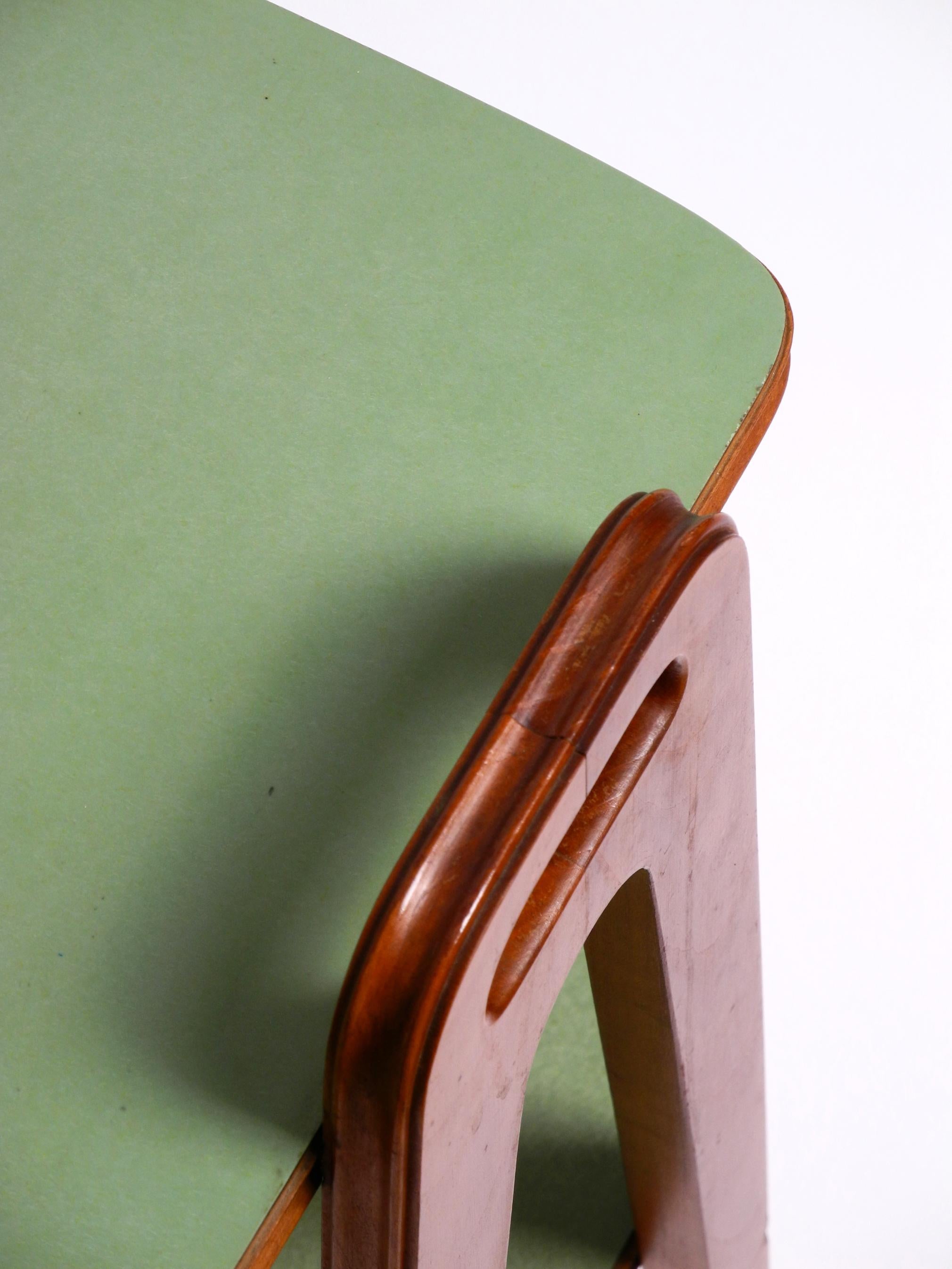 Small Mid Century Modern side table made of walnut with green Formica surfaces 1