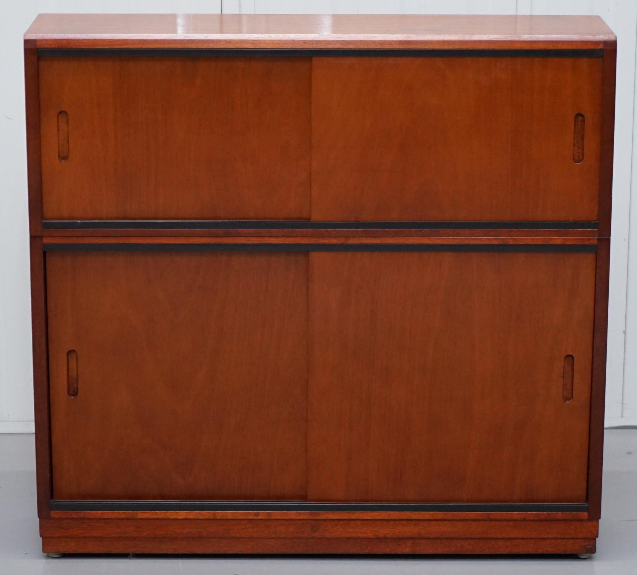We are delighted to this lovely vintage Mid Century modern stackable sideboard bookcase with sliding doors

A good looking and utilitarian piece, the bookcase is made up of two modular sections, if you can find who made it they would have sold