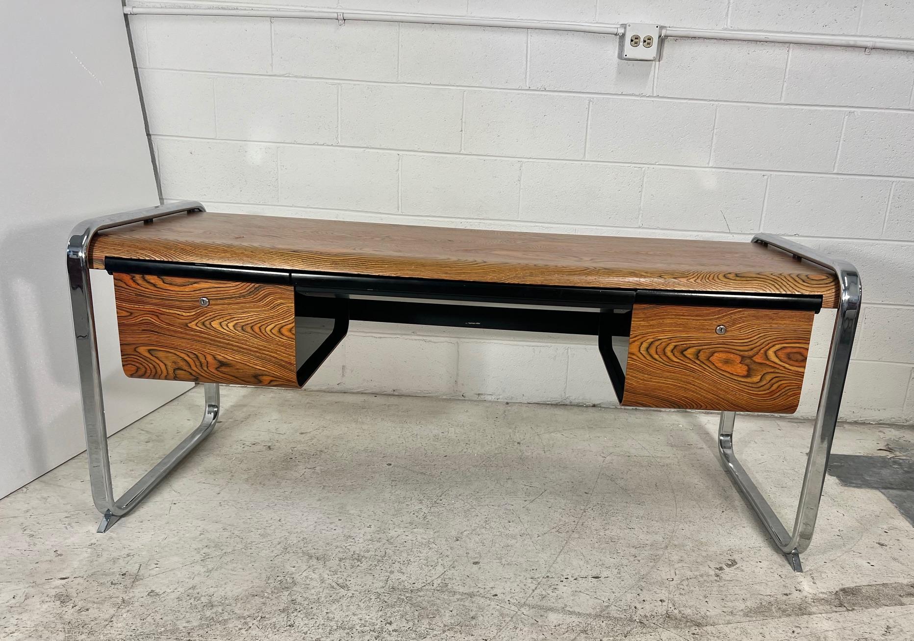 Mid-century modern zebra wood desk by Peter Protzman for Herman Miller.

Very good condition. No keys. Small gouges at the front of the desk. Other minor signs of wear from normal use.
Huge desk with lots of storage. This desk was produced only in