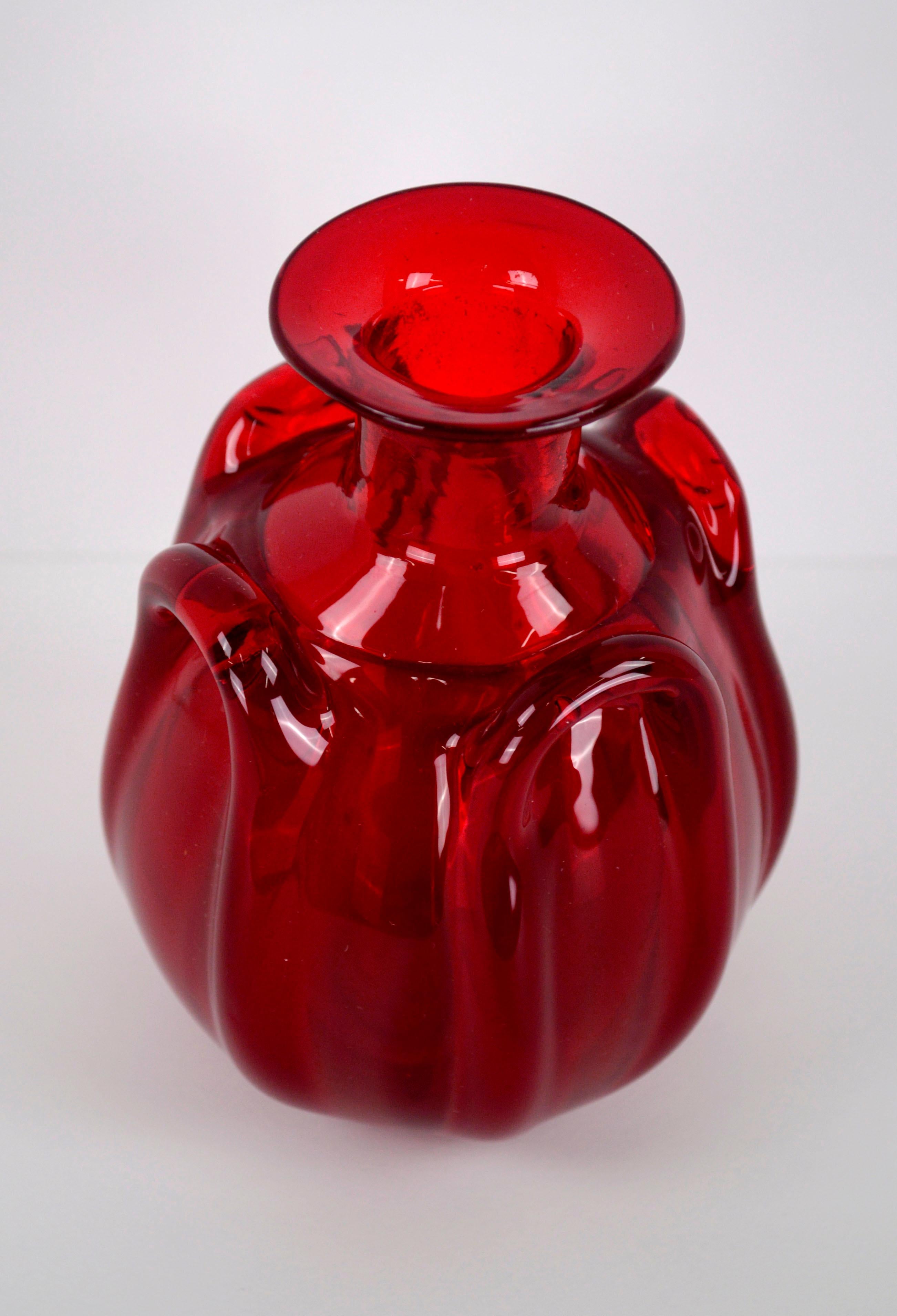 Small Mid-Century Modern Red Murano Glass Bud Vase

Bright translucent red hand blown Murano glass bud vase, with four large ridged details. One very small inclusion (firing blemish) on bottom edge, as shown in photos. Measures 4
