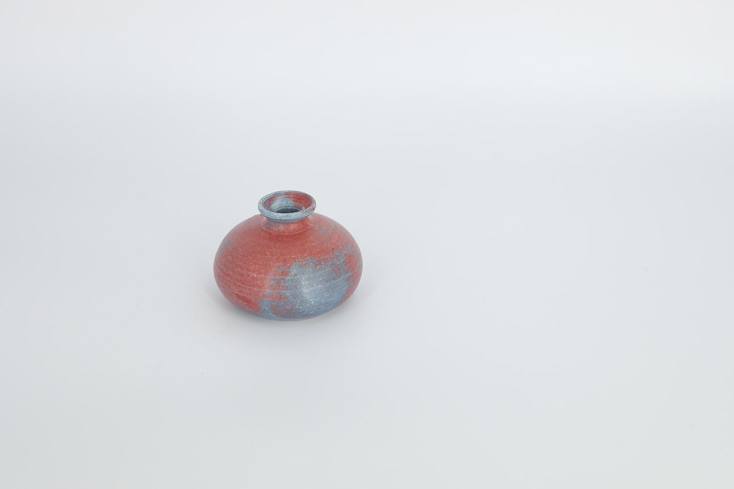 This miniature, collectible stoneware vase was made in Sweden during the 1960s. Handmade with the utmost care and attention to detail. A two-color vase in an irregular shade of amaranth and blue. Signed by the author.


This vase is in original