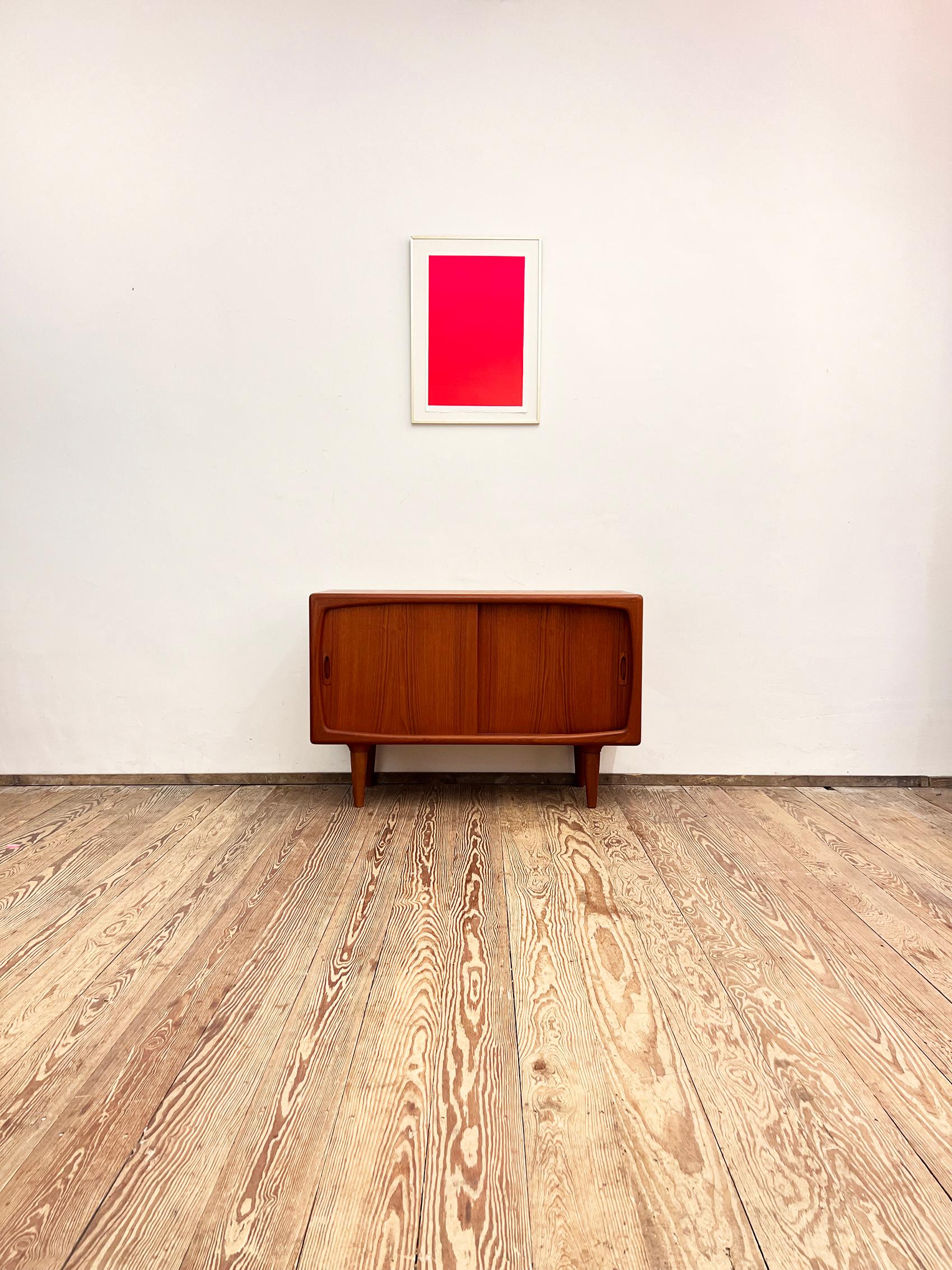 Dimensions: 120x45x80 cm (Width x Hepth x Height)

This Scandinavian mid century modern teak credenza was designed and produced in the 1950s by H.P. Hansen in Denmark.

It shows exquisite Danish craftsmanship and offers storage space behind two