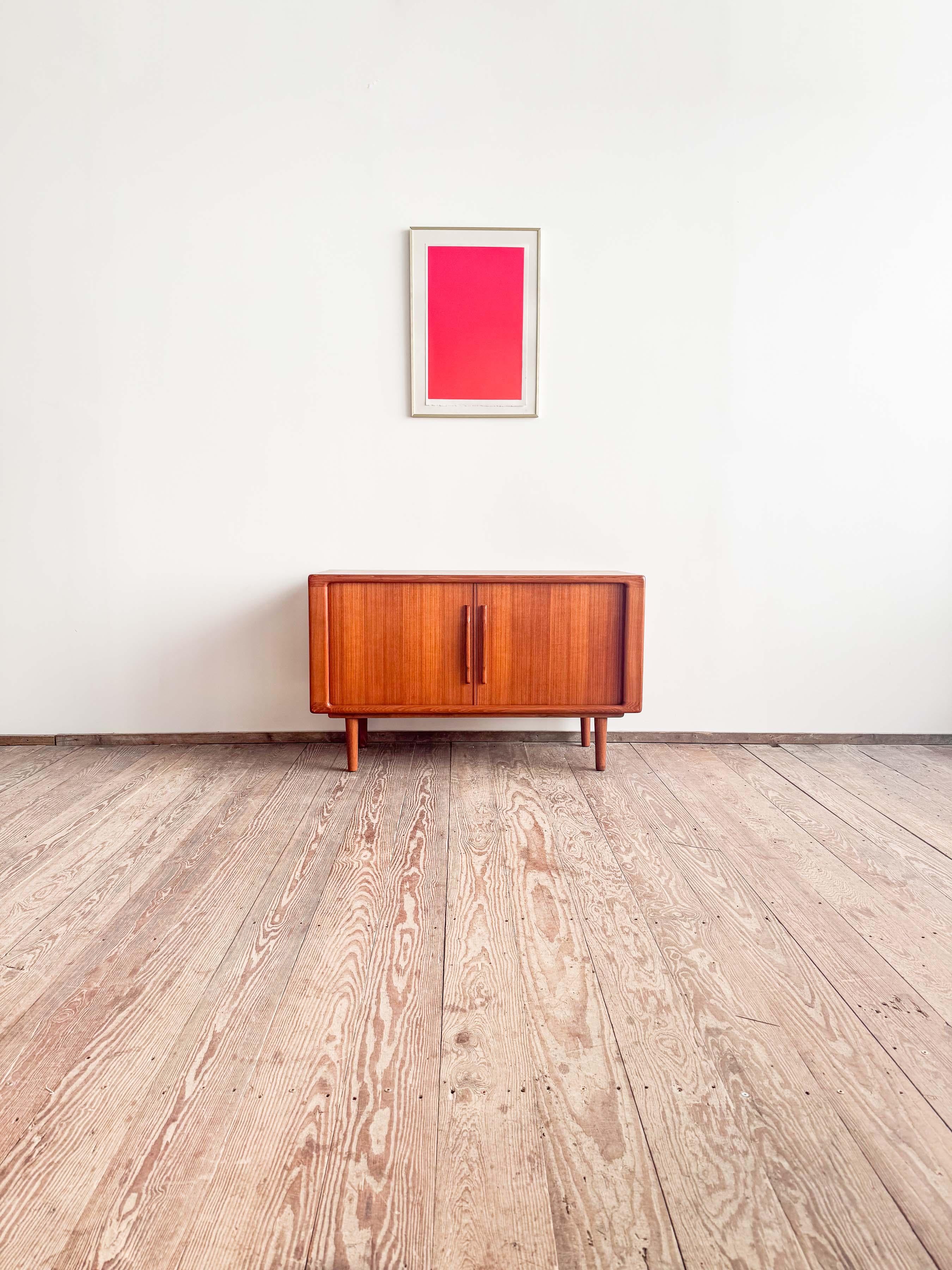 Dimensions: 120 x 49 x 72,5 cm (Width x Hepth x Height)

This Scandinavian teak credenza was designed and produced in the 1960s in Denmark.

It shows exquisite Danish craftsmanship and offers storage space behind two tambour doors and lots of
