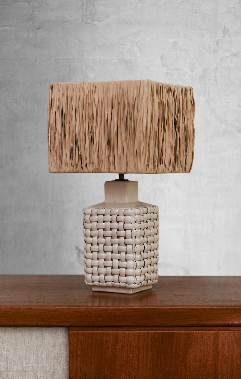 Small Mid-Century Table Lamp by Tommaso Barbi, 1970
Product Details
Made of glazed ceramic with a crossed rattan motif.
Complete with raffia lampshade.
Dimensions: 22.5 W x 43 H x 22.5 D cm