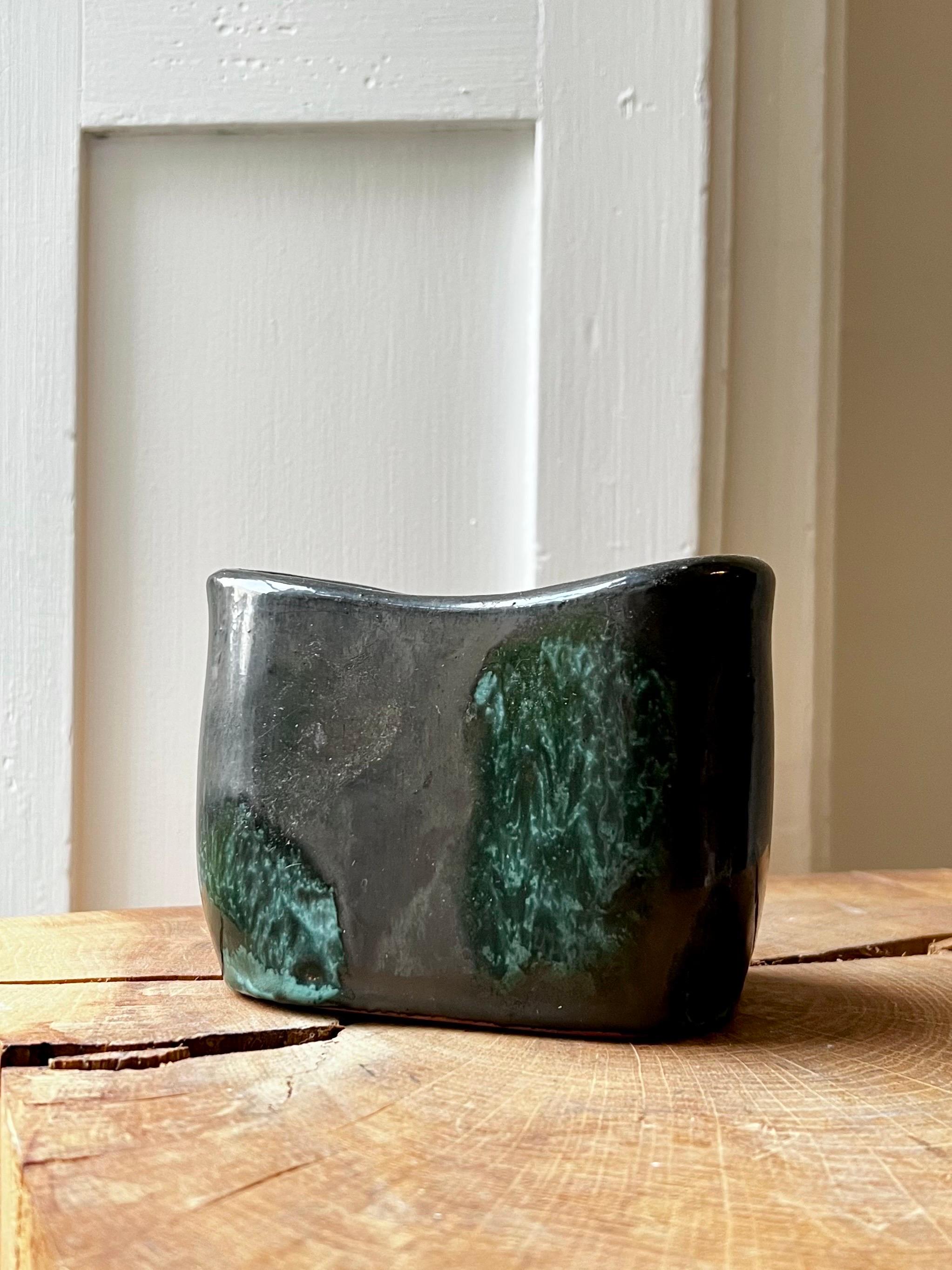 A small stoneware vase by the highly-regarded Swedish ceramicist Hans Hedberg (1917 - 2007). Glazed to the outside in grey-black with green-blue highlights; the grey-black glaze continues inside. The piece is in good vintage condition, with minor