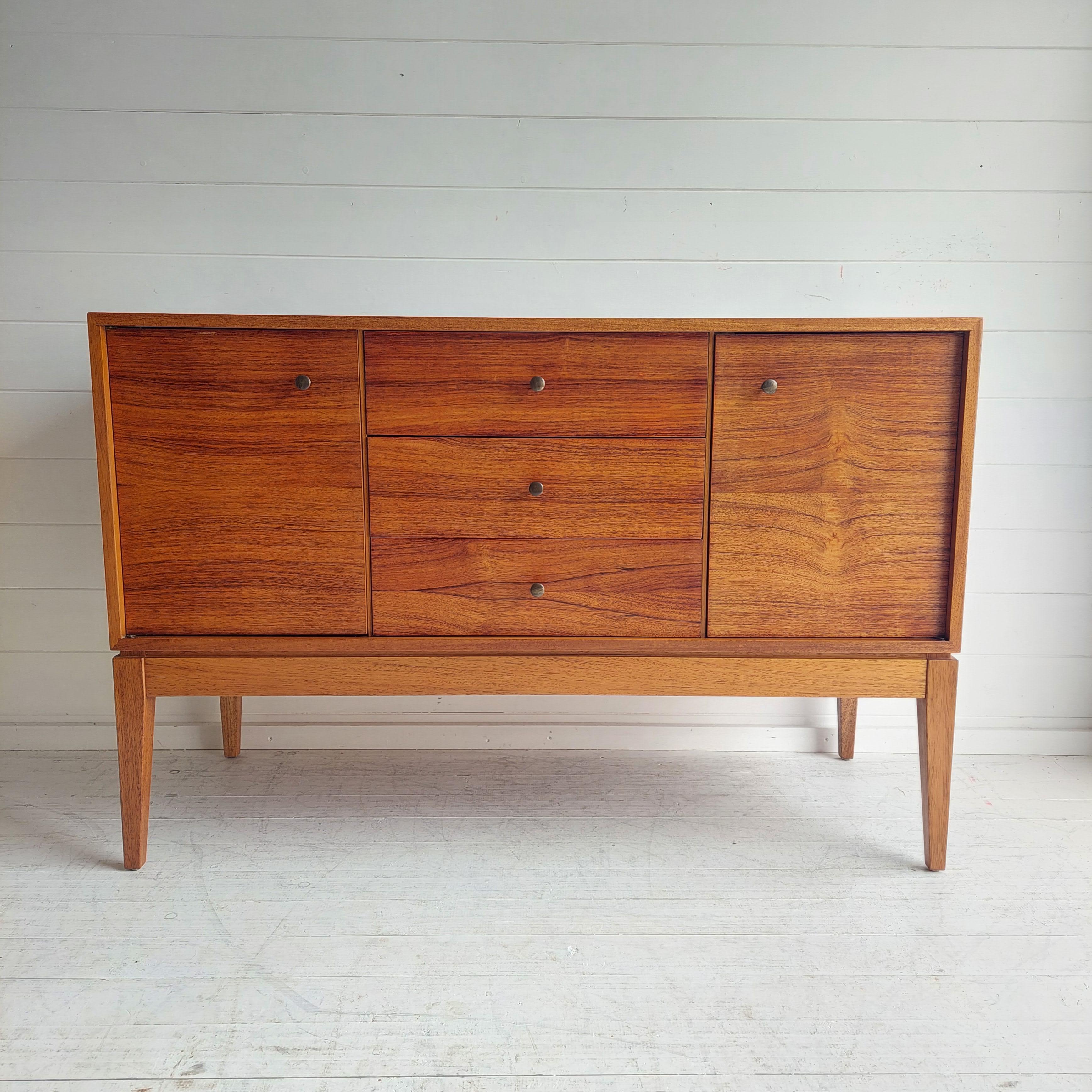 A beautifully designed and rare Mid Century sideboard designed by Peter Hayward for Uniflex of Great Britain.
Restored condition

Featuring contrasting walnut  drawers and door fronts which contrast beautifully with the main carcass of the unit, and
