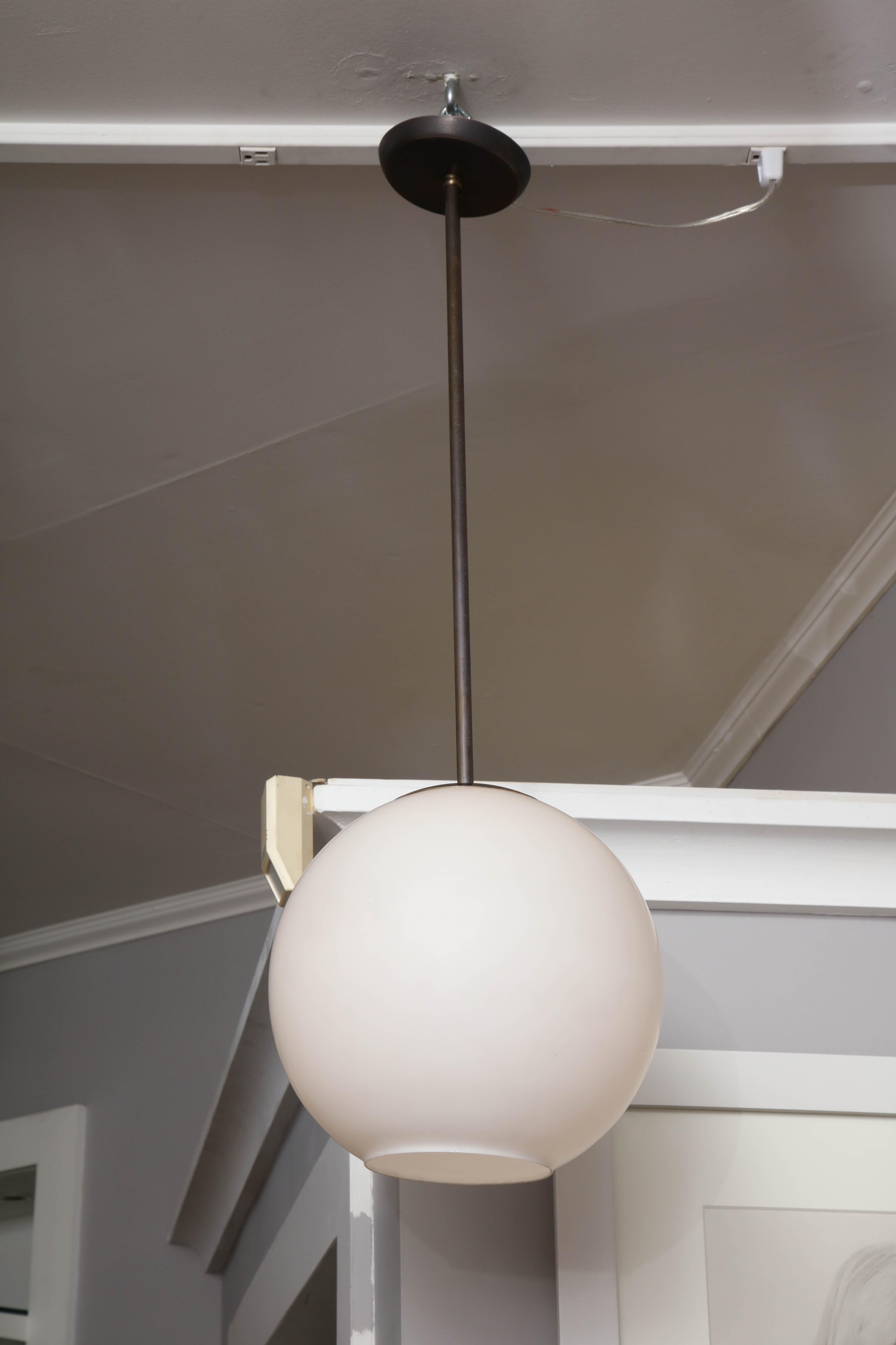 A small voluminous globe lightens up all directions and creates a simple, elegant statement for any room. Some minor blemishes and scratches show consistent with its age.
 