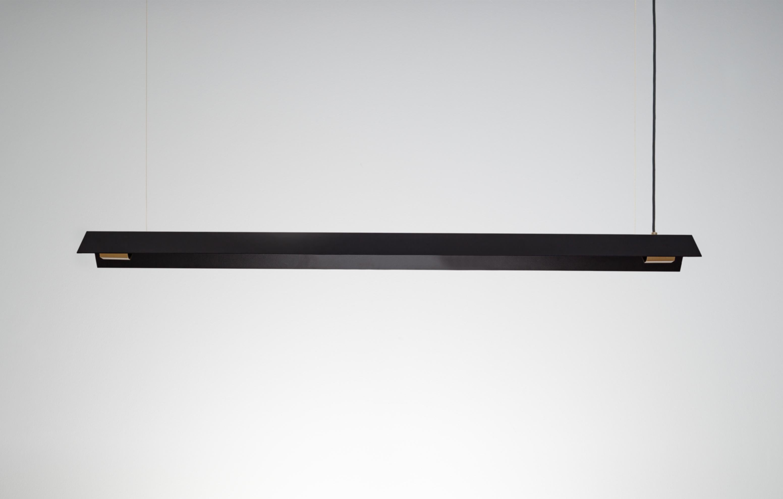 Small Misalliance Ex Jet Black Suspended Light by Lexavala
Dimensions: D 16 x W 70 x H 8 cm
Materials: powder coated shade with details made of brass or stainless steel.

There are two lenghts of socket covers, extending over the LED. Two short