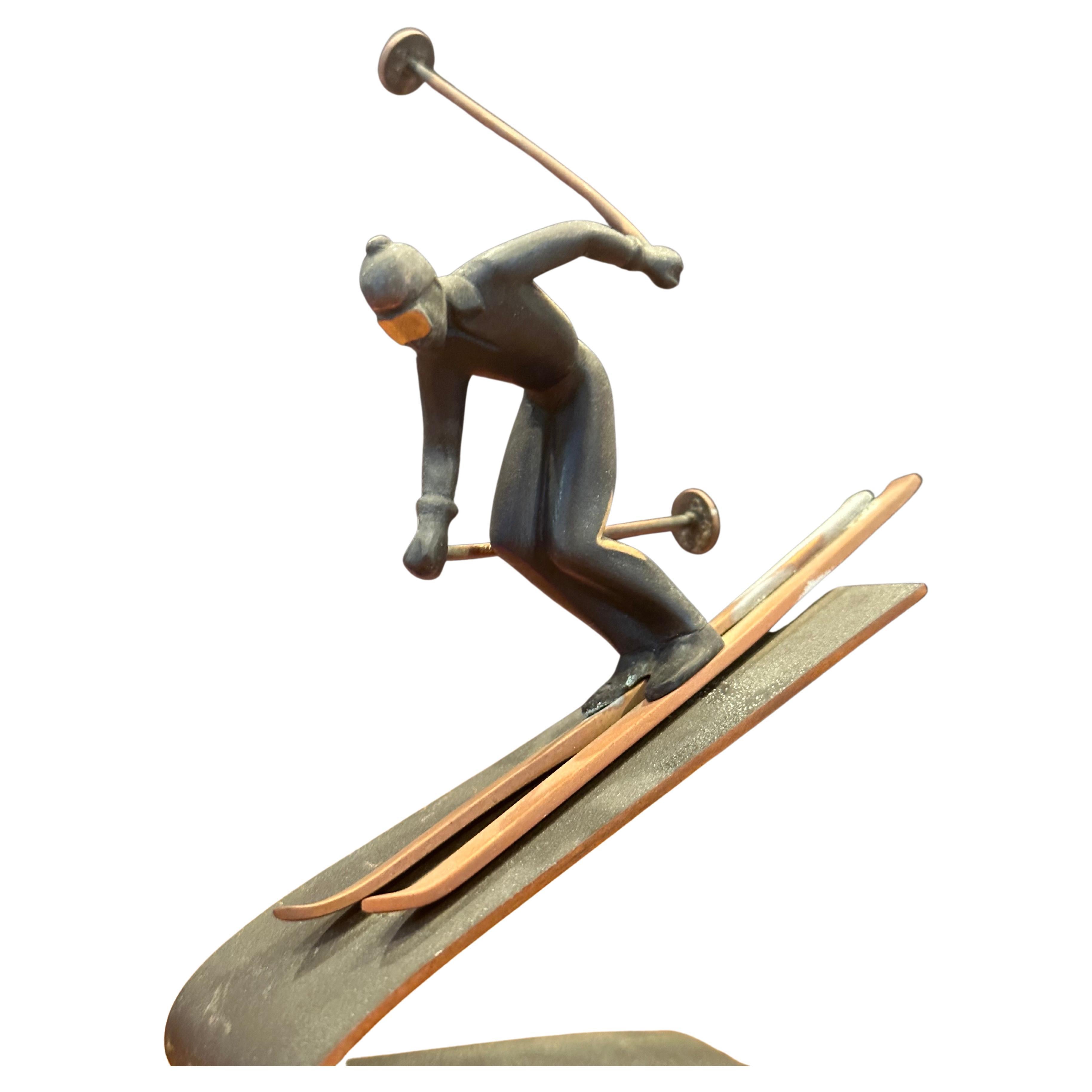 A very cool small mixed metals downhill skier sculpture, circa 1980s. The piece is signed 