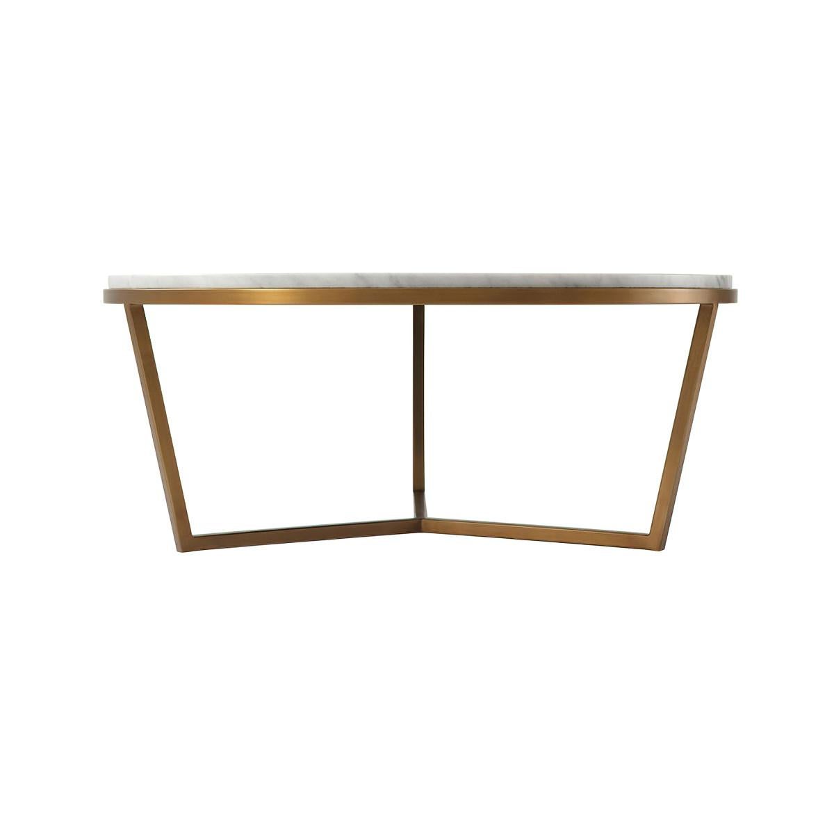 A small modern marble top cocktail table with a stepped edge. The circular Bianco Carrara marble top sits on a brushed brass finish base. 

Dimensions: 35.5