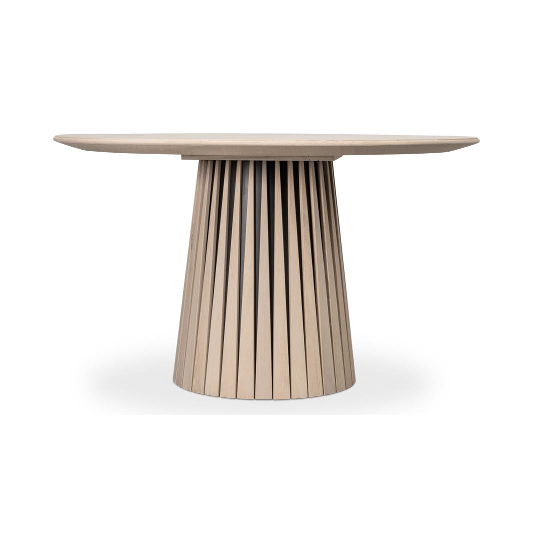 The brushed light grey finish on oak offers a rustic elegance that seamlessly blends contemporary design with timeless charm. 

Perfect for intimate gatherings, this table's unique base design adds a touch of sophistication to any room. Whether