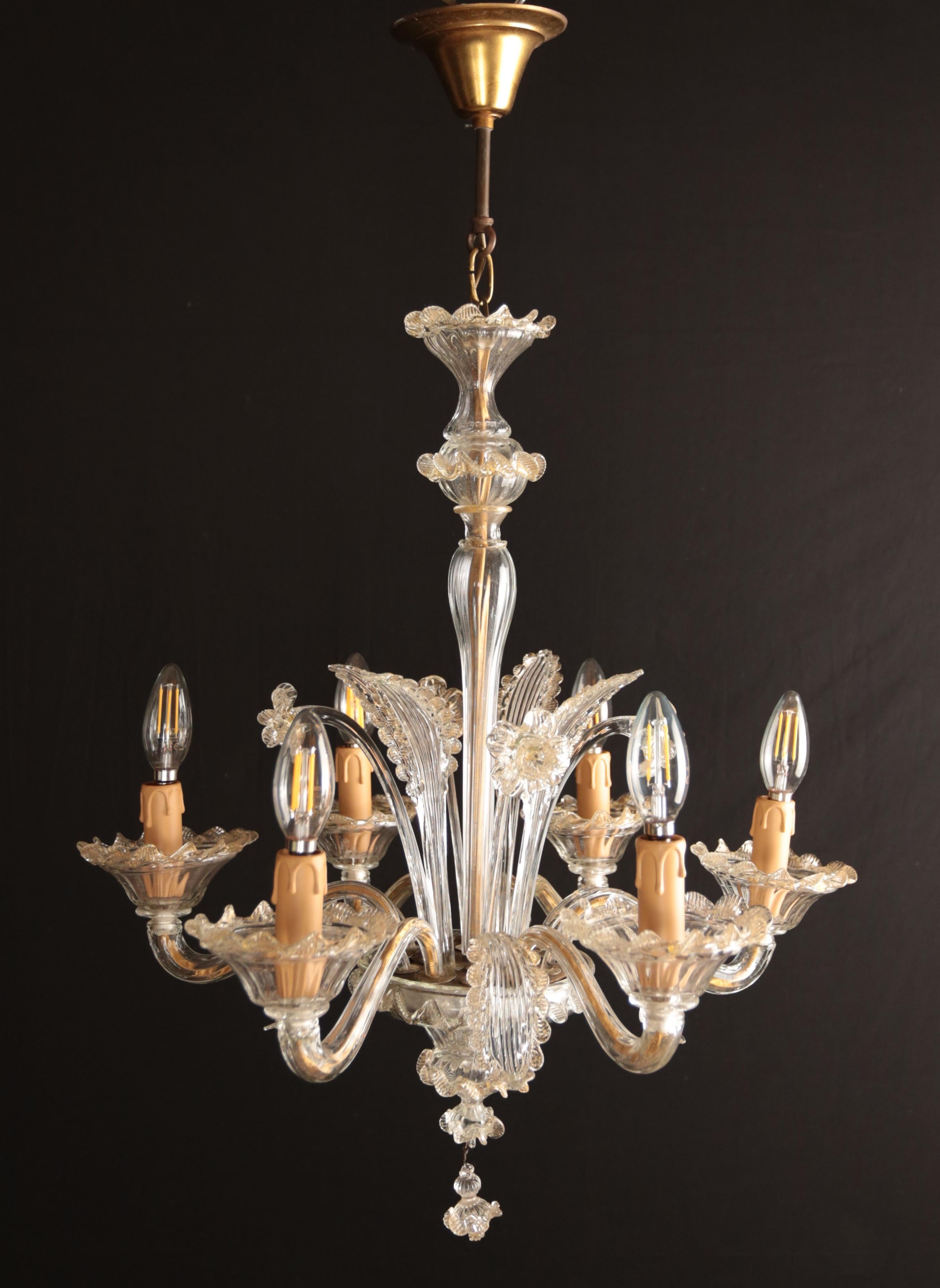 Small Murano Venetian chandelier

Glass chandelier made on Murano. Handcrafted from chipped glass. Beautiful lamp with plant motifs in soft gold - clear colors. The chandelier is for 6 bulbs with an E14 socket - normal, halogen and LED bulbs up to