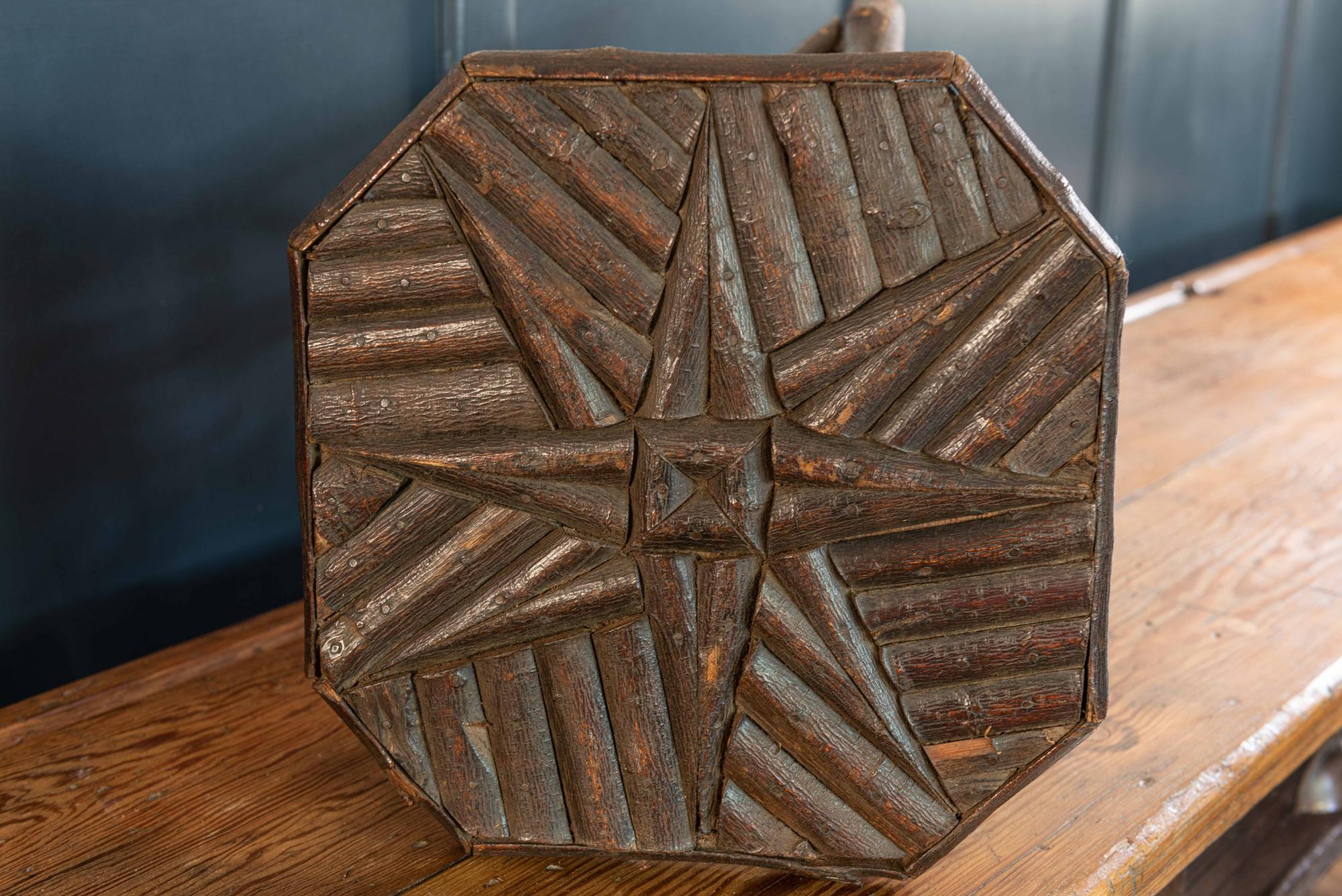 Small naive hazel wood twig stool/side table, early 20th century.
A decorative star shaped pattern top made with halved branches mounted on thick X-formed branch legs. An interesting artisan made tactile piece of furniture.

Measures: W 29, D 29,