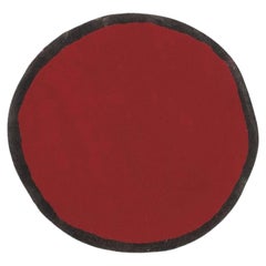 Petit tapis rond « Aros » de Nanimarquina en rouge et noir