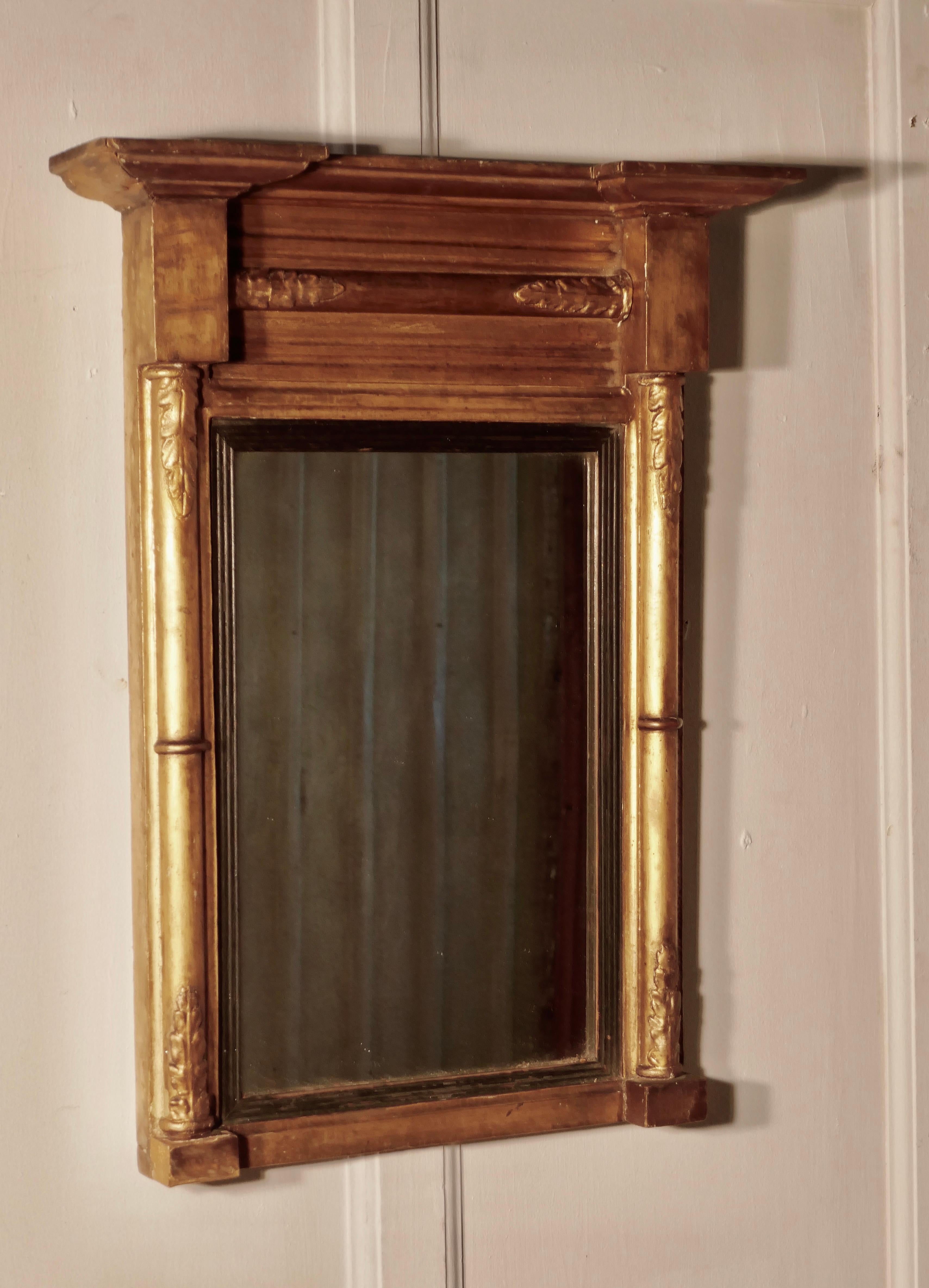 Small Napoleon III French carved gilt wall mirror

This is an elegant French mirror, the Frame is decorated with columns along the top and at each side of the looking glass
The mirror frame is in age darkened gold, the looking glass is original,