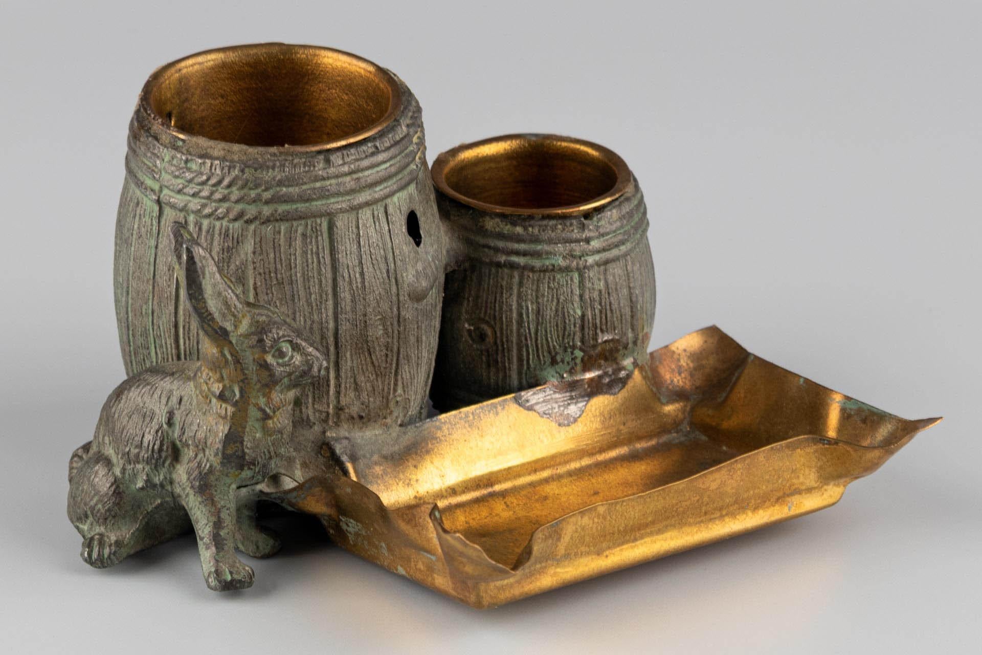 Metal Small naturalistic desk set with rabbit and barrels made of patinated metal For Sale