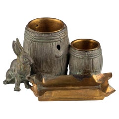 Antique Small naturalistic desk set with rabbit and barrels made of patinated metal