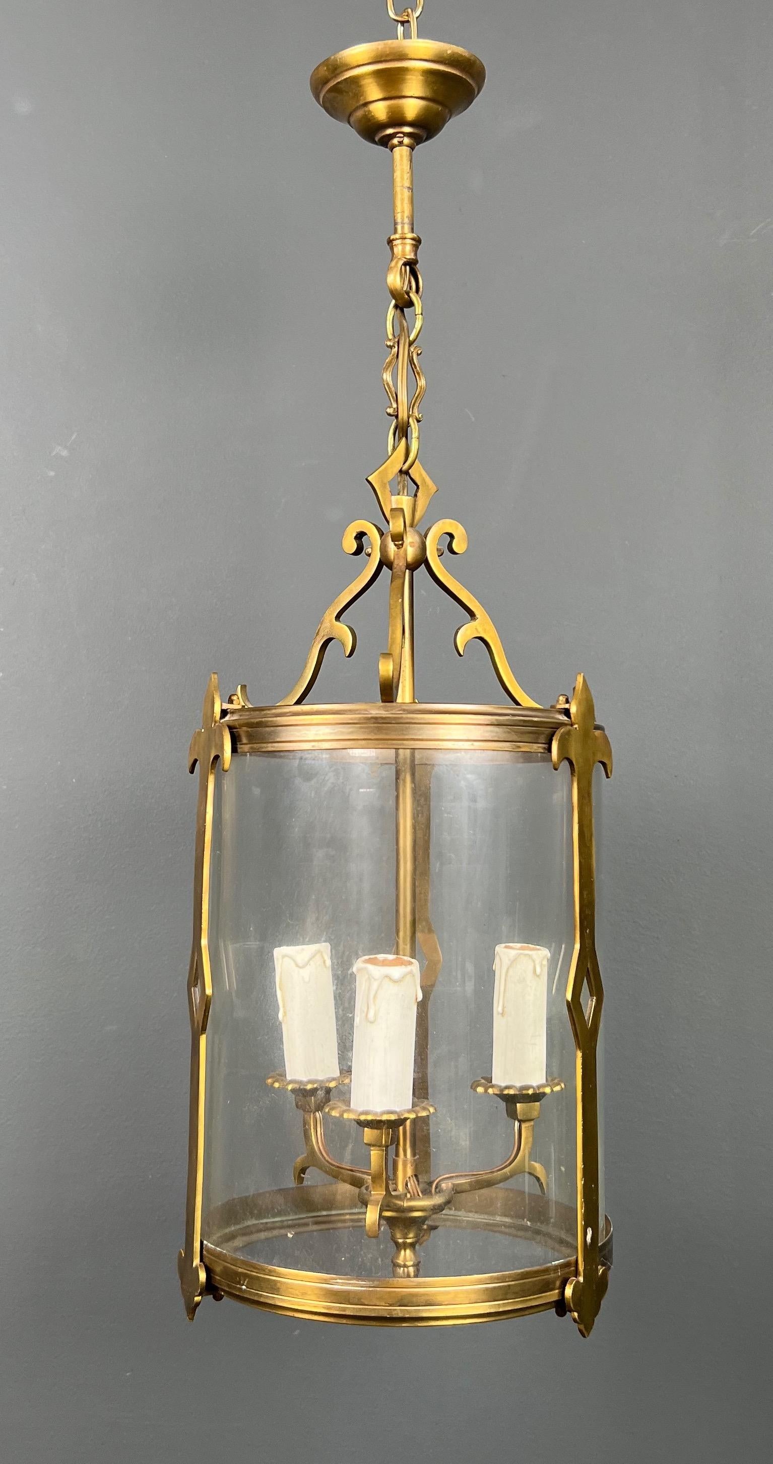 This small neoclassical style lantern is made of bronze with round glass. This is a French work. Circa 1940 (Height doesn't include chain and canopy)