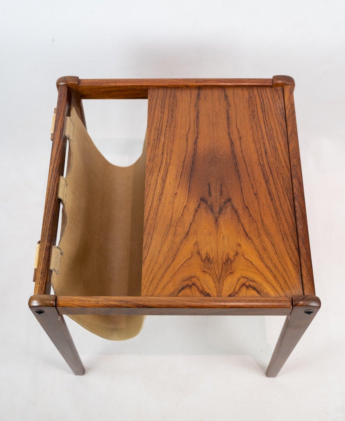 Small newspaper holder/lamp table i rosewood of Danish design from the 1960s. The table is in great vintage condition.
  