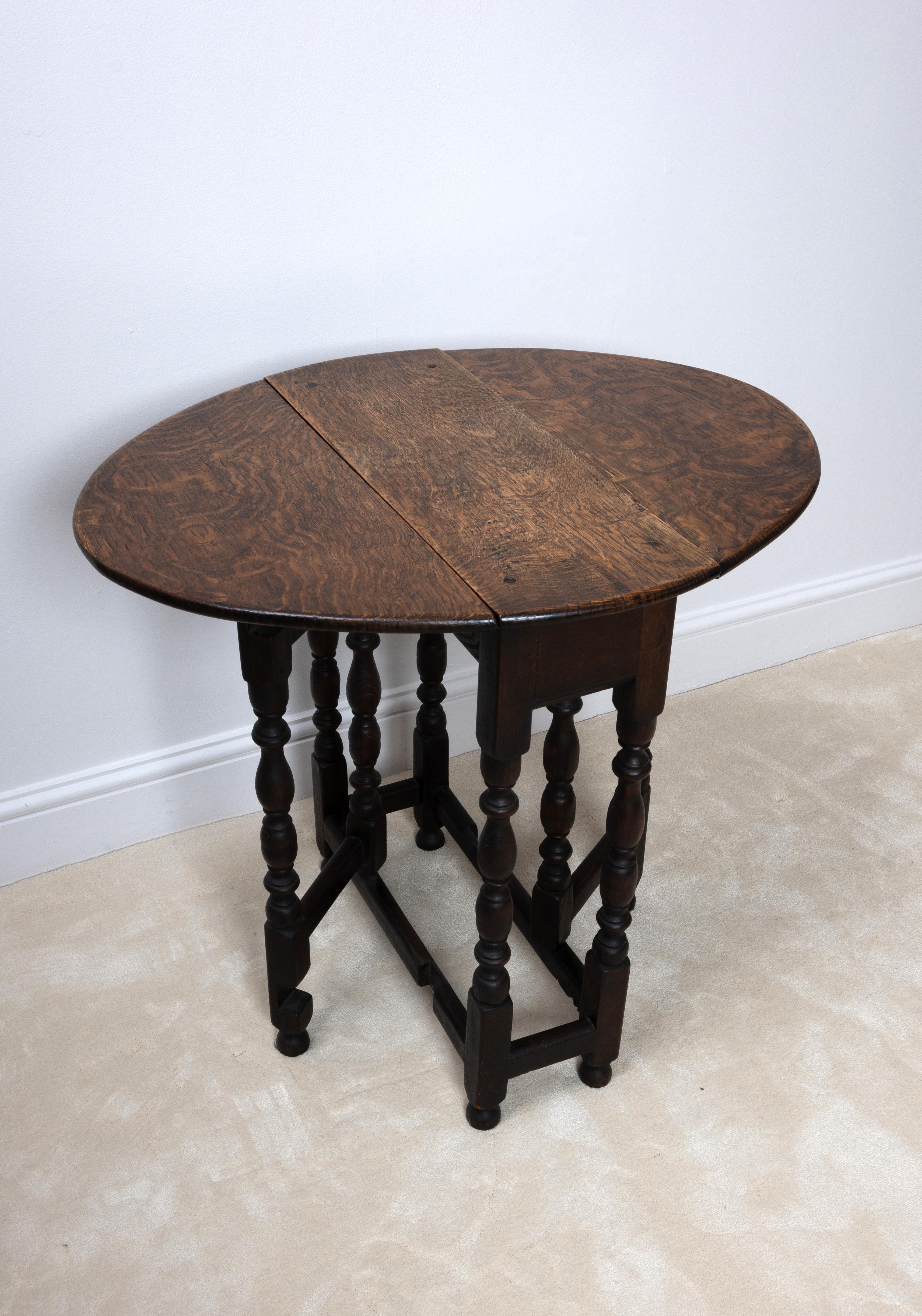Small Oak 17th Century Style Gate Leg Drop Leaf Table 
C.1920
Ideal for many uses (Side, end, window, supper table)
Very compact in size when closed.
In very good condition commensurate of age.

Dimensions:
H:68cm
D58cm
L:22/73cm