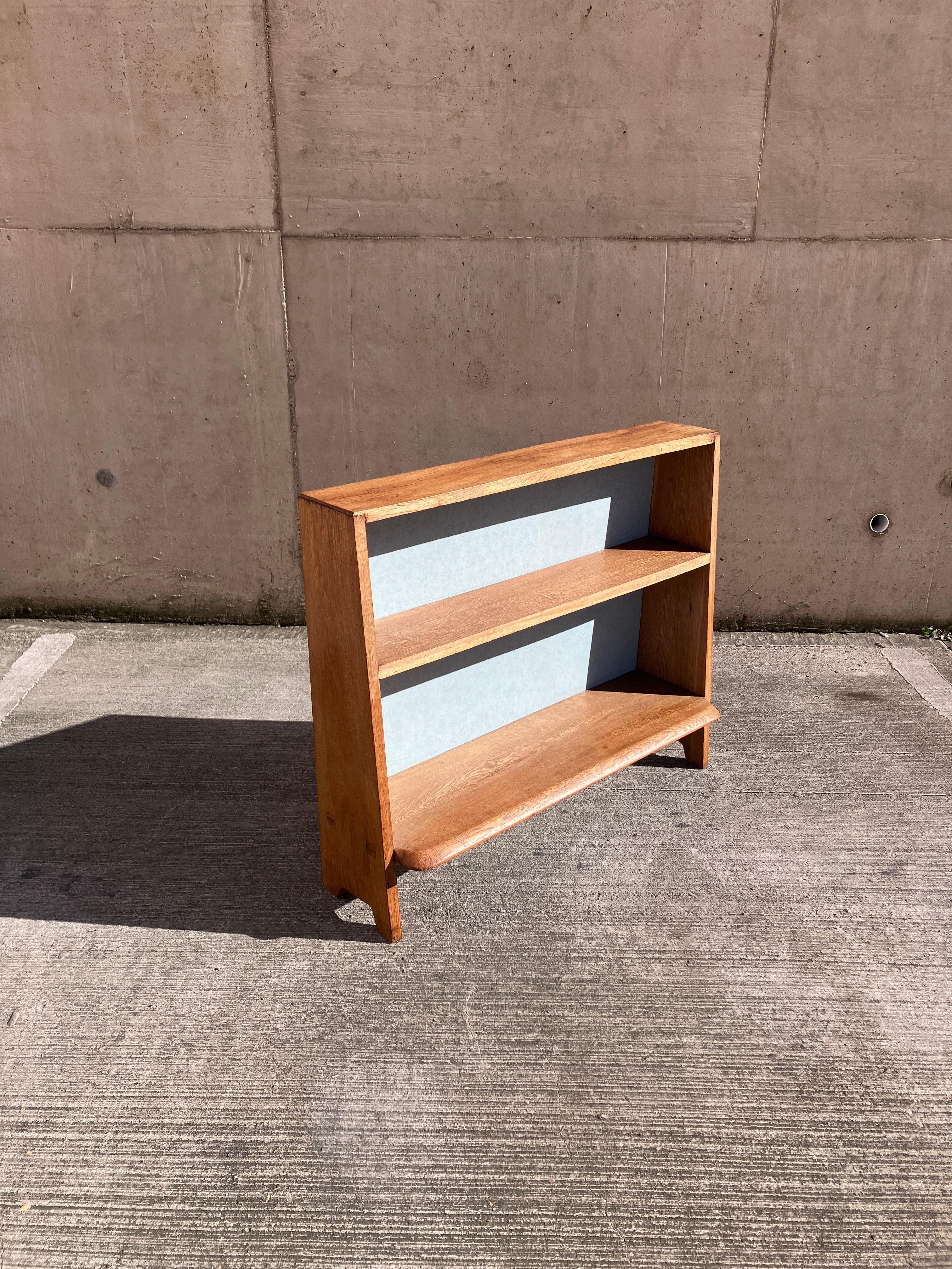 Beautifully made mid-century bookcase in Oak. The vintage freestanding bookcase has a cascading front and a lovely chunky, shaped bottom shelf. 
Gorgeous colour and patina to the oak. A lovely 50's piece of furniture. Very Ercol like. 

Overall size