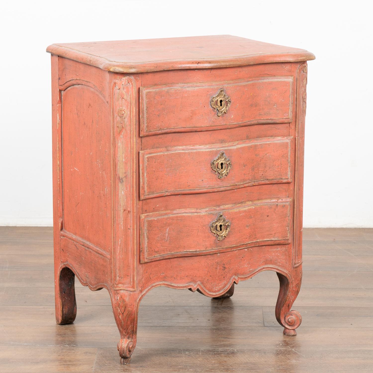 A small oak rococo chest of three drawers with brass key escutcheons. The scalloped edge is carried down through the 3 drawer fronts and bottom apron resulting in an elegant chest all resting on four elongated cabriole legs.
The newer,