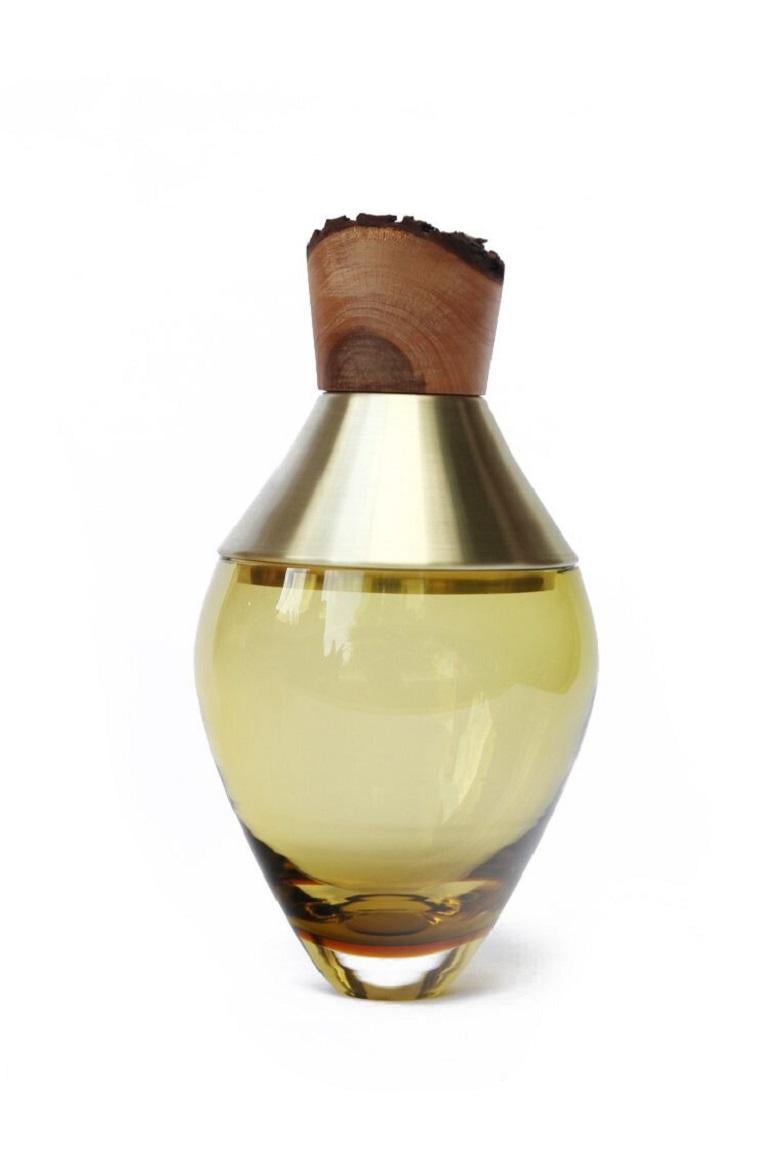 Small Olive India vessel I, Pia Wüstenberg.
Dimensions: D 15 x H 30.
Materials: glass, wood, metal.
Available in other metals: brass, copper, copper patina.

Handmade in Europe, by individual craftsmen: handblown glass (Czech Republic), hand