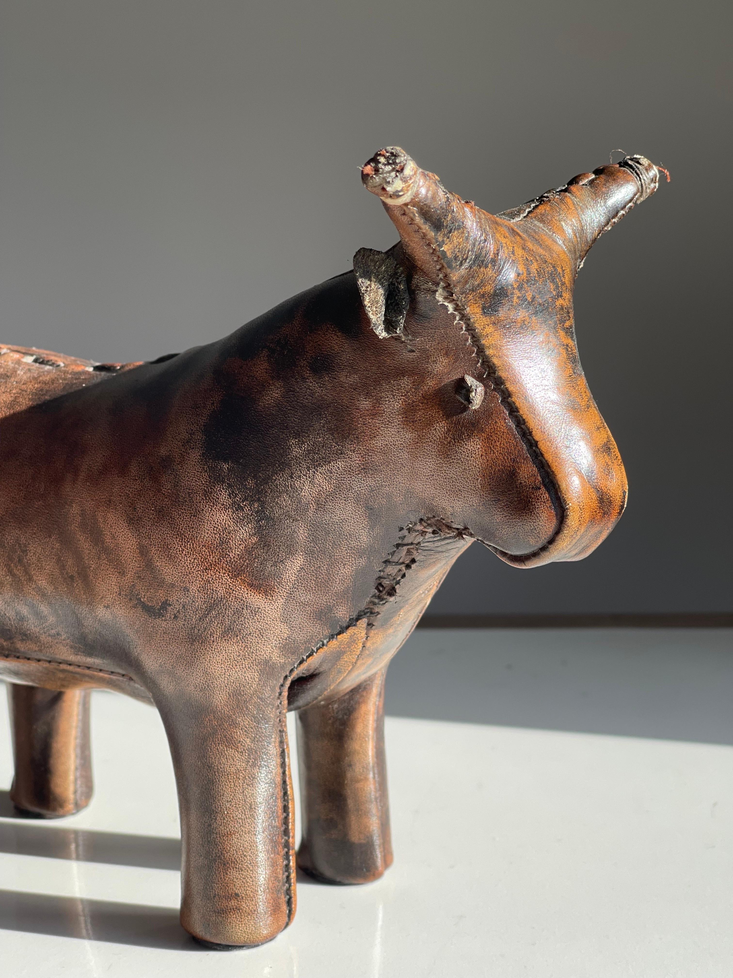 Lovely expressive diminutive doorstop stitched leather bull by Dimitri Omersa for Valent. 1960's. Everything looks nice, wonderful patina, strong and fully stitched tail, ears and eyes. Can be used as decor or a desk weight or door stop etc.