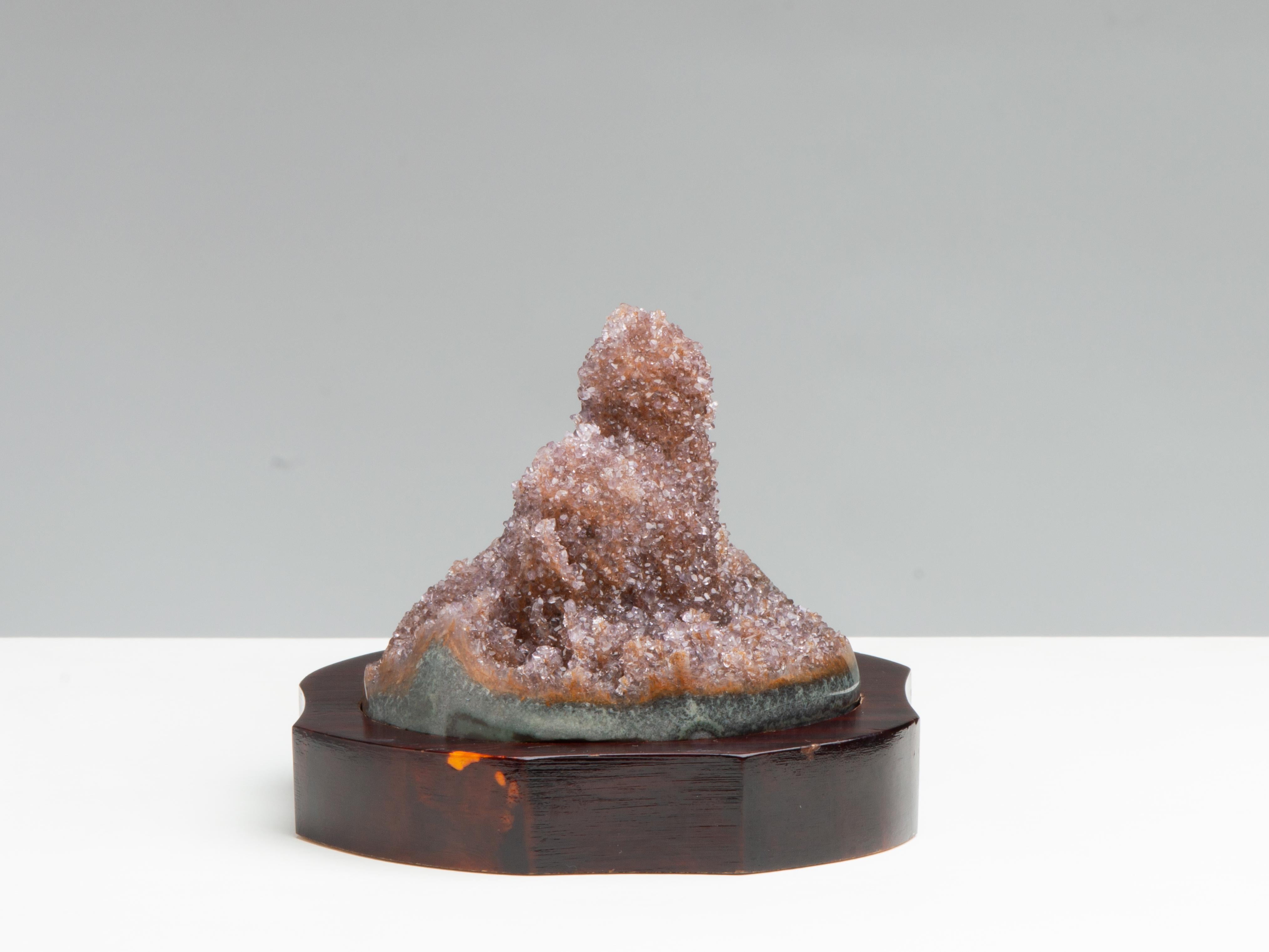 A small piece preserving a beautiful stalactite covered in orange-tan druzy quartz. The lower edges polished to reveal a relatively thick celadonite shell.

Measures: Dimensions of stone: H 8cm x W 9cm x D 9cm 
Dimensions of stone with base: H