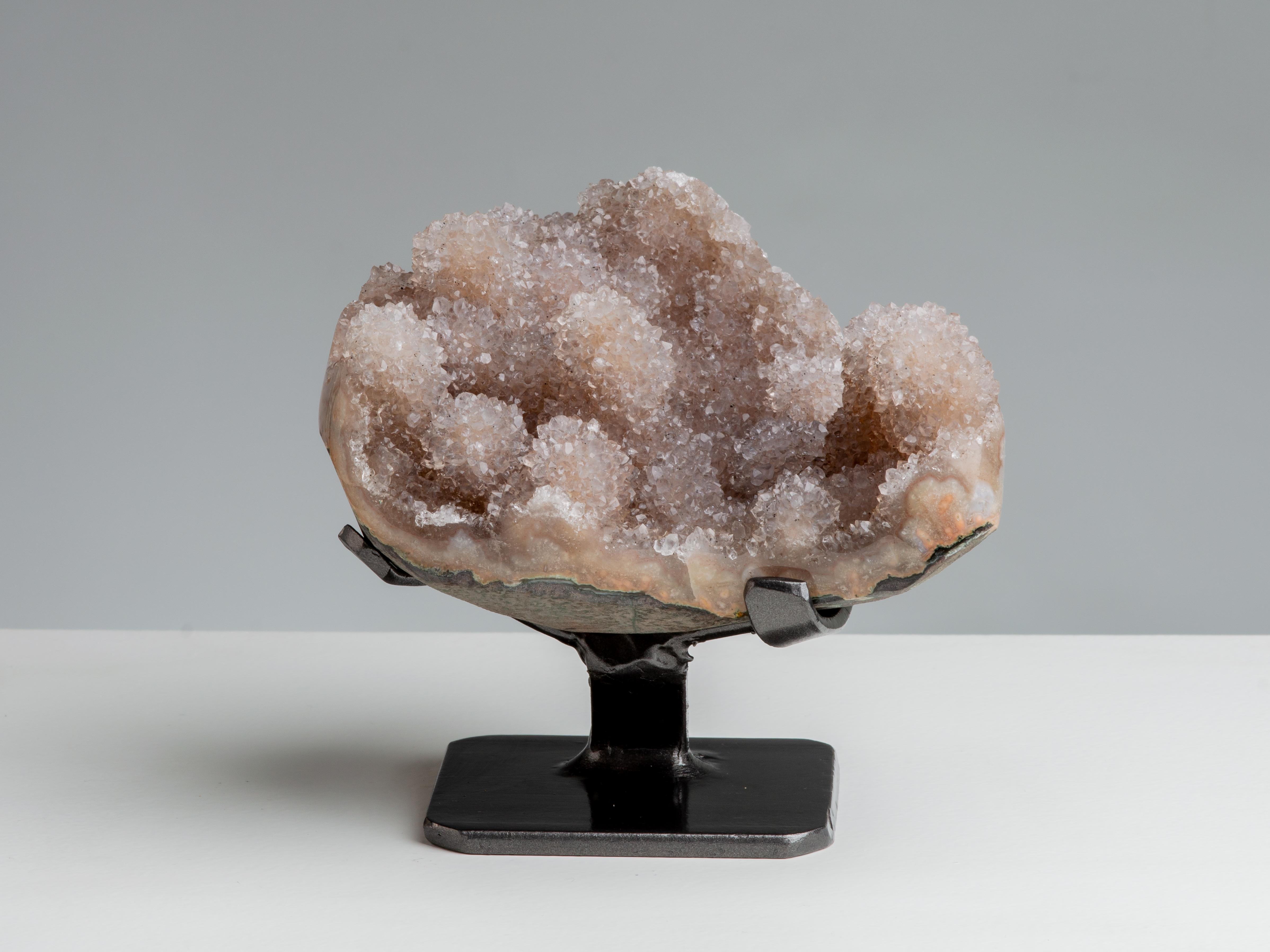 Several small stalactites adorn this piece, covered in light orange druzy quartz.

This piece was legally and ethically sourced directly in the prestigious mines of Uruguay, South America. Uruguayan amethyst is internationally recognized as being