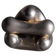 Small organic sculpture made of chrome-plated metal