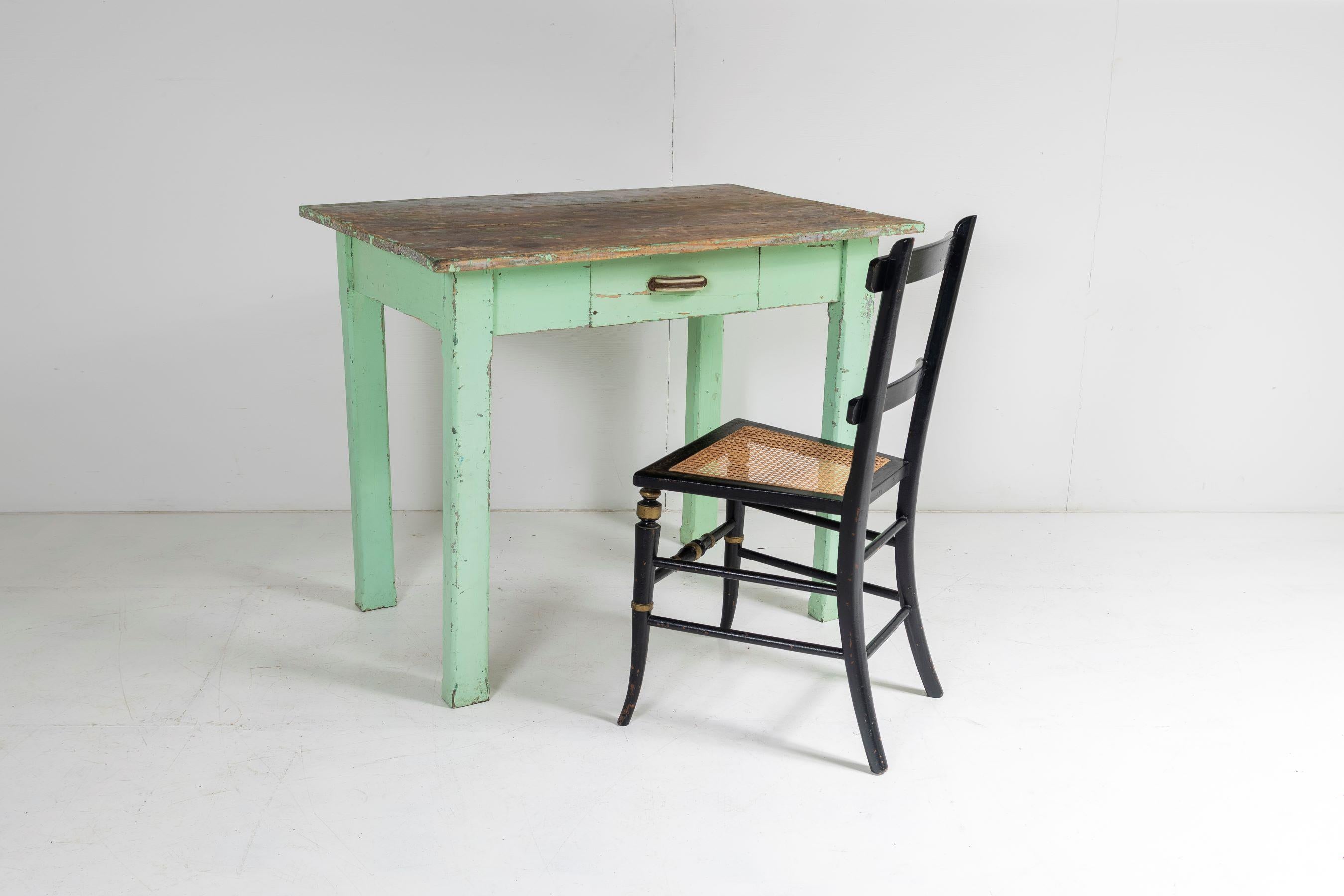 A completely original painted pine Welsh farmhouse table in a fantastic green colour.  This would have originally been a small kitchen table, a primitive simply made table yet highly decorative.  Early 1900s, this example would work equally well as