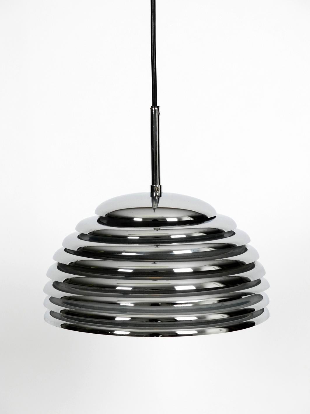 Small original Saturno chrome metal pendant lamp by Kazuo Motozawa for Staff from the 1970s.
High quality minimalistic design. Lampshade is consisting of several individual metal rings, which are chrome-plated at the outside and painted white