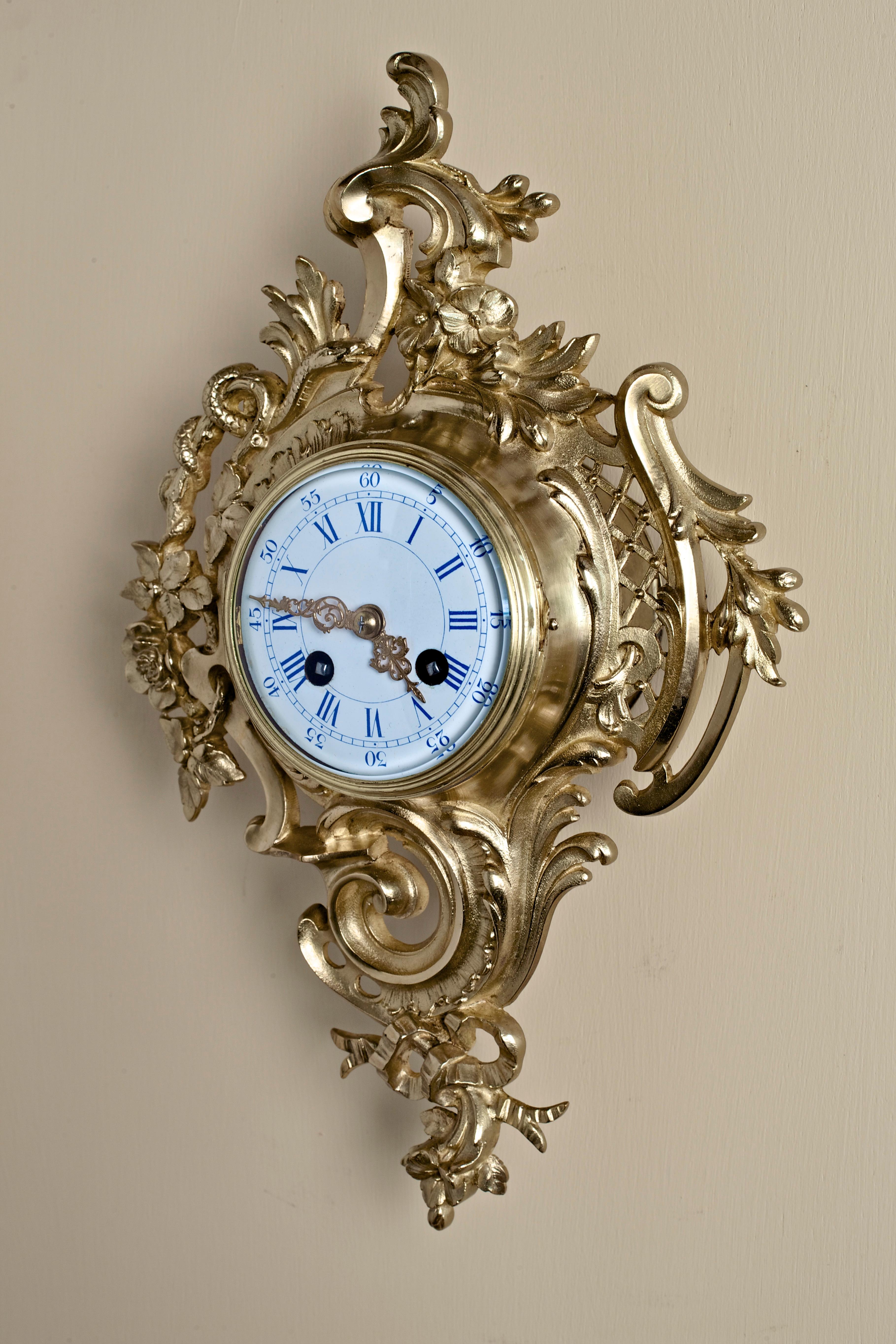 Small French Ormolu Cartel clock in a finely decorated case. 

Enamel dial with Roman numerals and original gilded hands.

 Eight day French movement striking the hours and halves on a silvered bell, circa 1880.