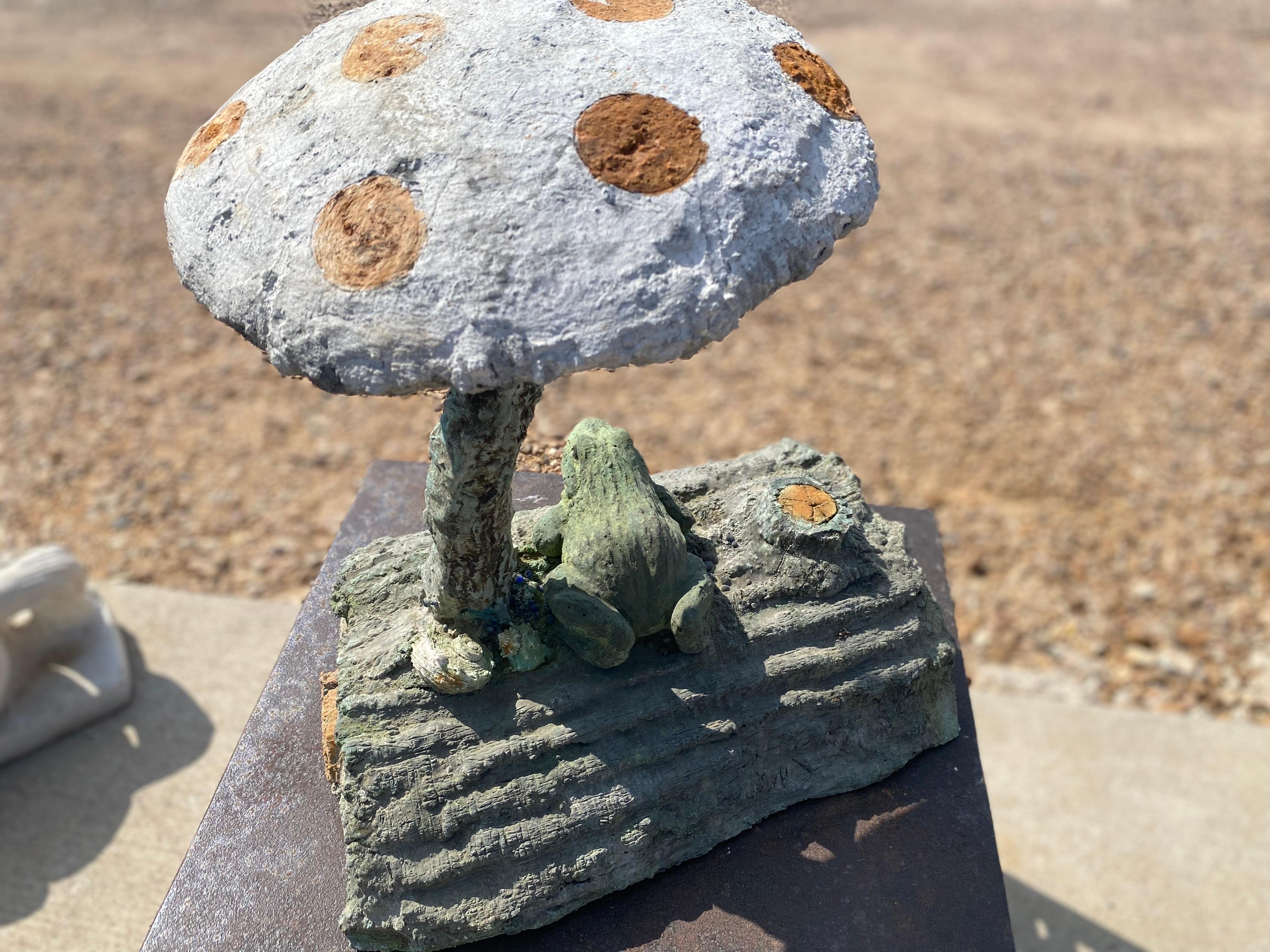 Concrete outdoor frog mushroom garden sculpture by Rene Romero, a San Antonio, Texas faux bois artist. Sculptor Rene Romero learned the art of faux bois from famed master artisan Carlos Cortes. This yard ornament is made of concrete and hand