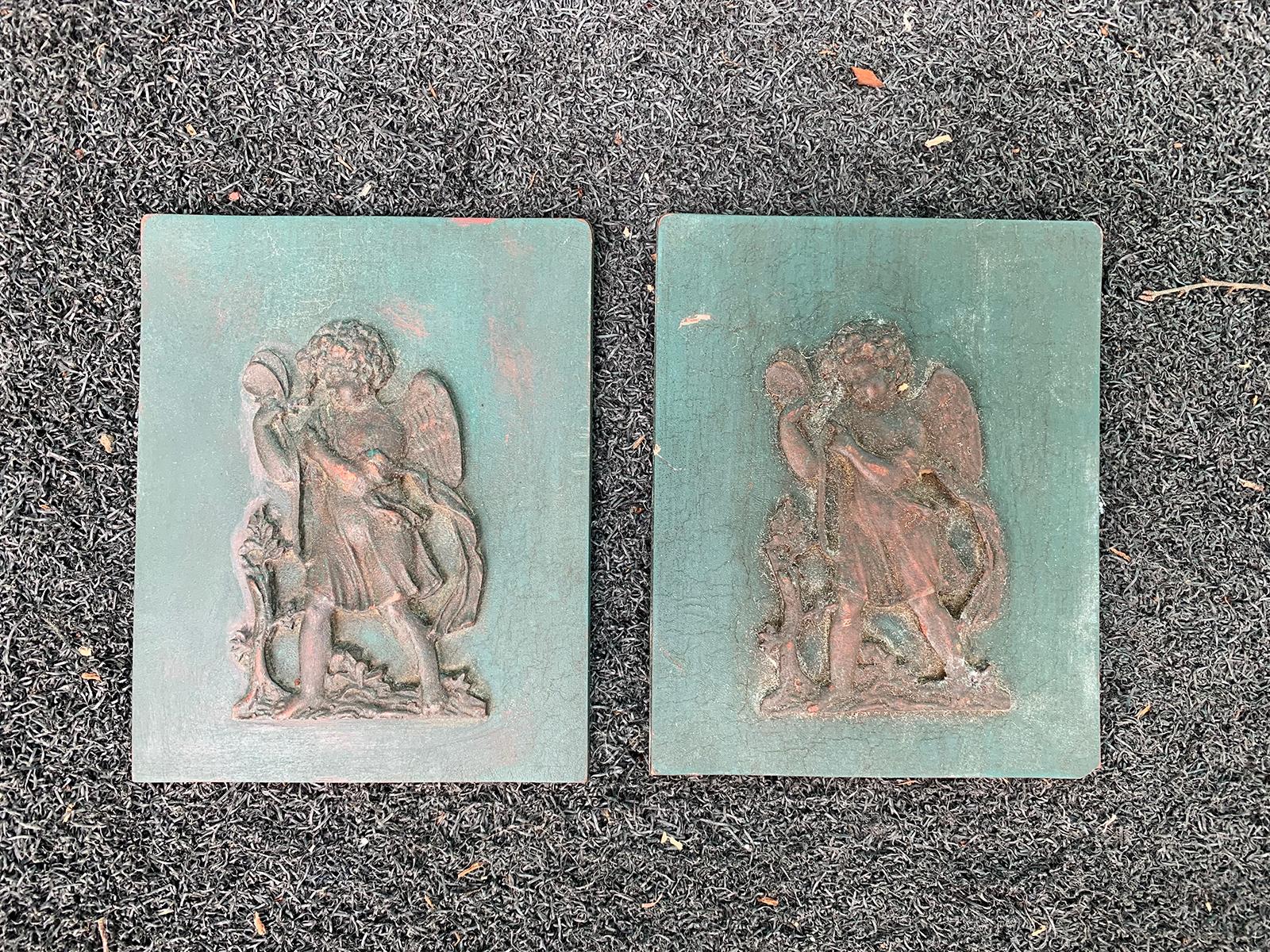 Small pair of 19th-20th century carved wooden plaques with putti.