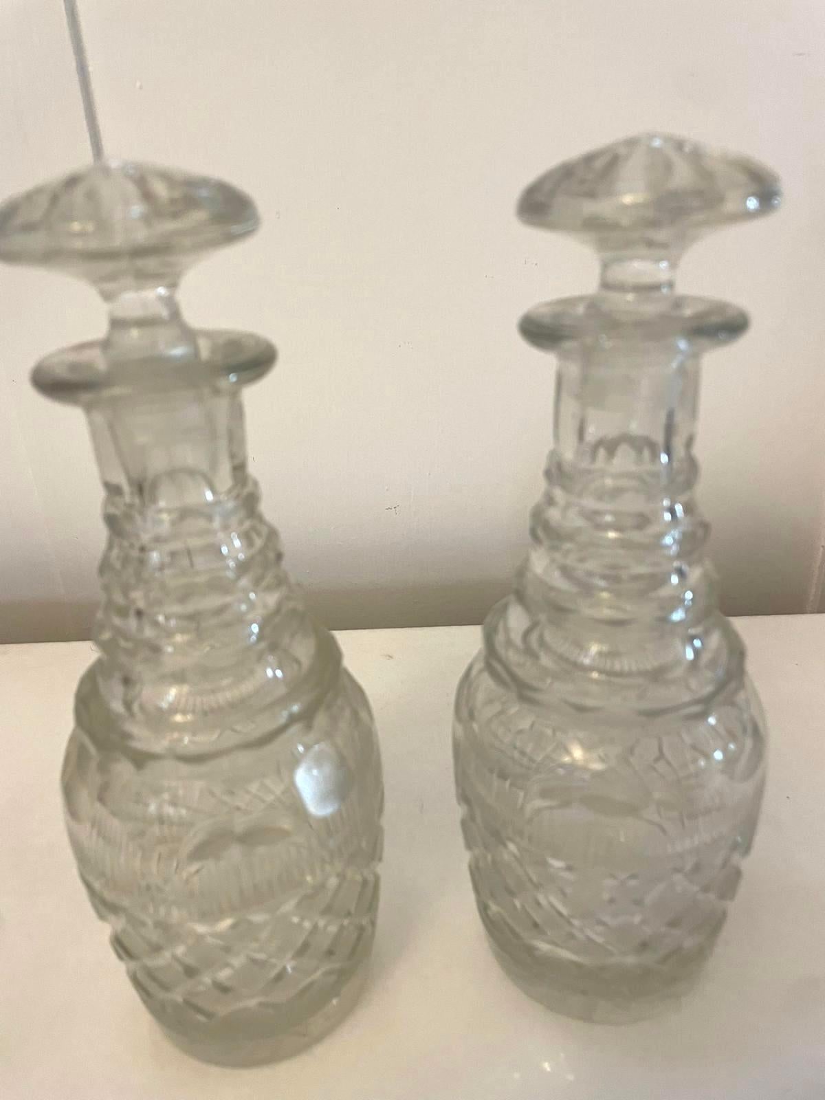 Small pair of antique George III quality cut glass decanters with original stoppers 

A quaint pair in perfect original condition and of desirable proportions

Dimensions:
Height 19.5 cm (7.67 in)
Width 7 cm (2.75 in)
Depth 7 cm (2.75