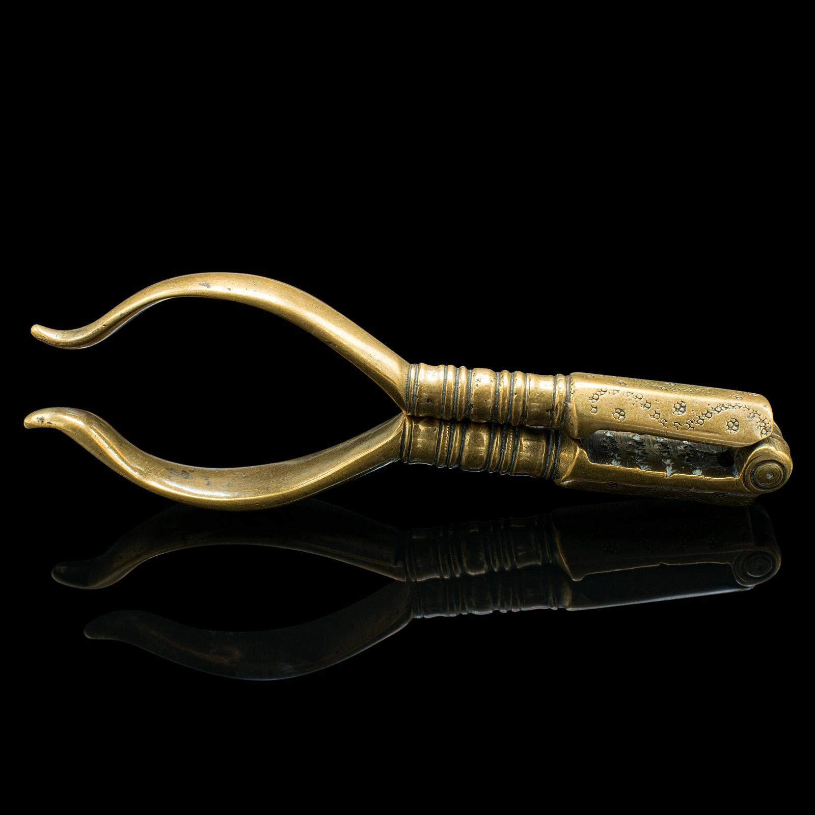 This is a small pair of antique pistachio nutcrackers. An English, brass hand tool, dating to the Georgian period, circa 1800.

Charmingly diminutive with appealing Georgian craftsmanship
Displaying a desirable aged patina and in good order