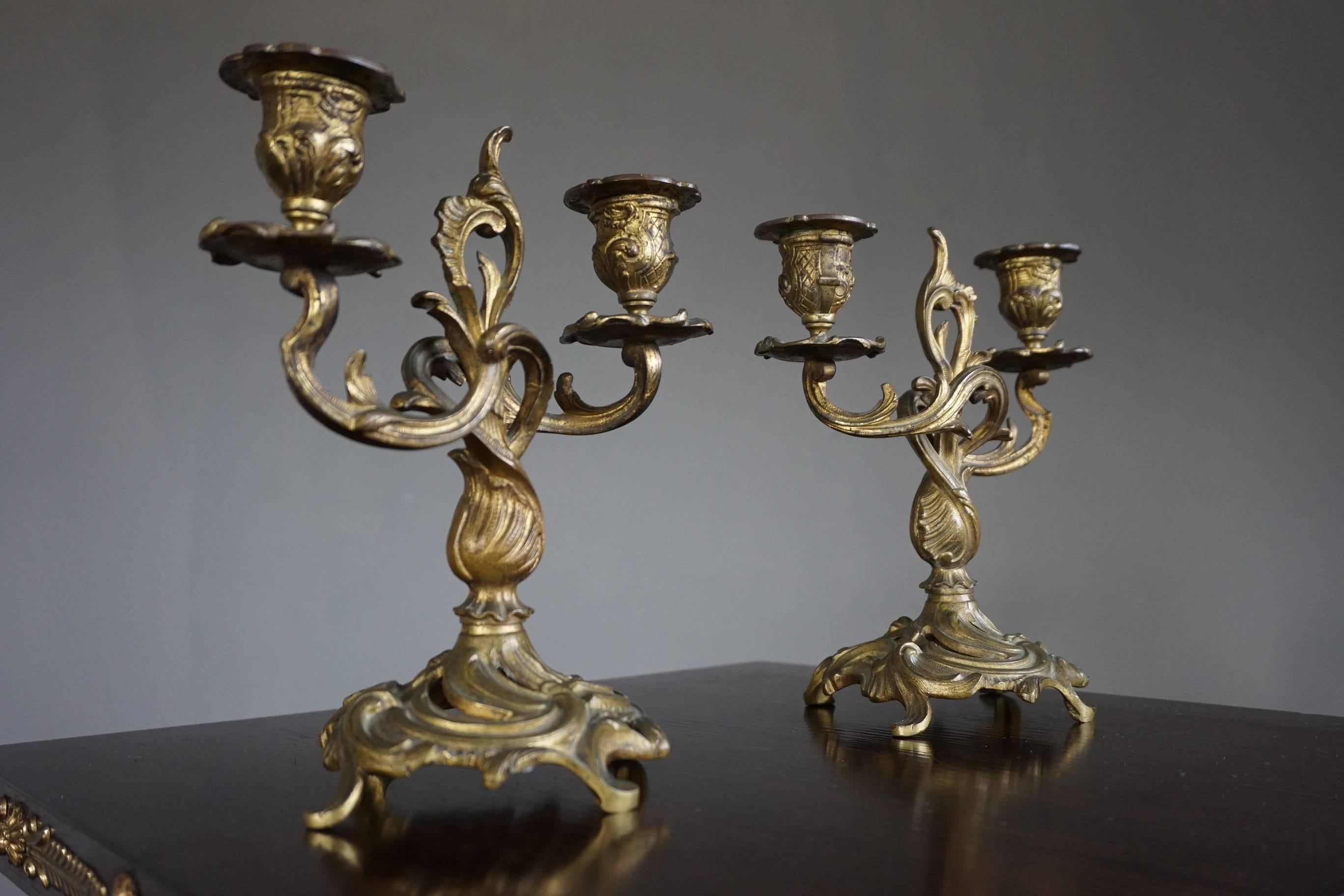 Very elegant and stylish candelabras with their original bobeches.

This graceful pair of antique bronze candelabras will look marvelous in the middle of a small table, on a dresser or side table or anywhere else for that matter. Over the many