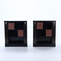 Small pair of ebonized open bookcases having bronze circa 1940.