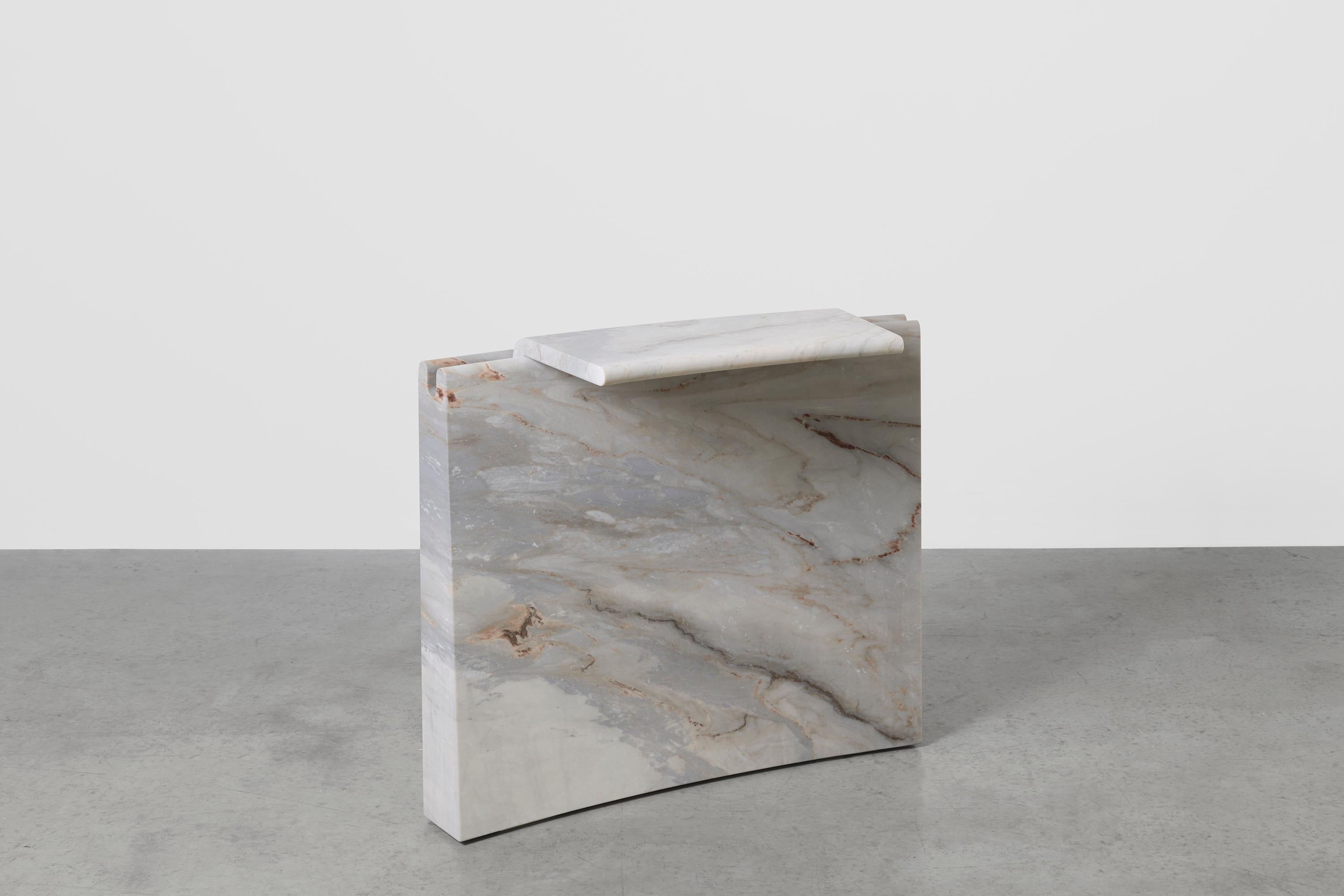 Small Palissandro Bluette marble mass x Fred Ganim
Dimensions: W 93 x D 36 x H 80 cm.
Materials: Palissandro bluette marble.

Grounded by its weight, the sheer mass of the material uses gravity as a structural force, cantilevering a system of