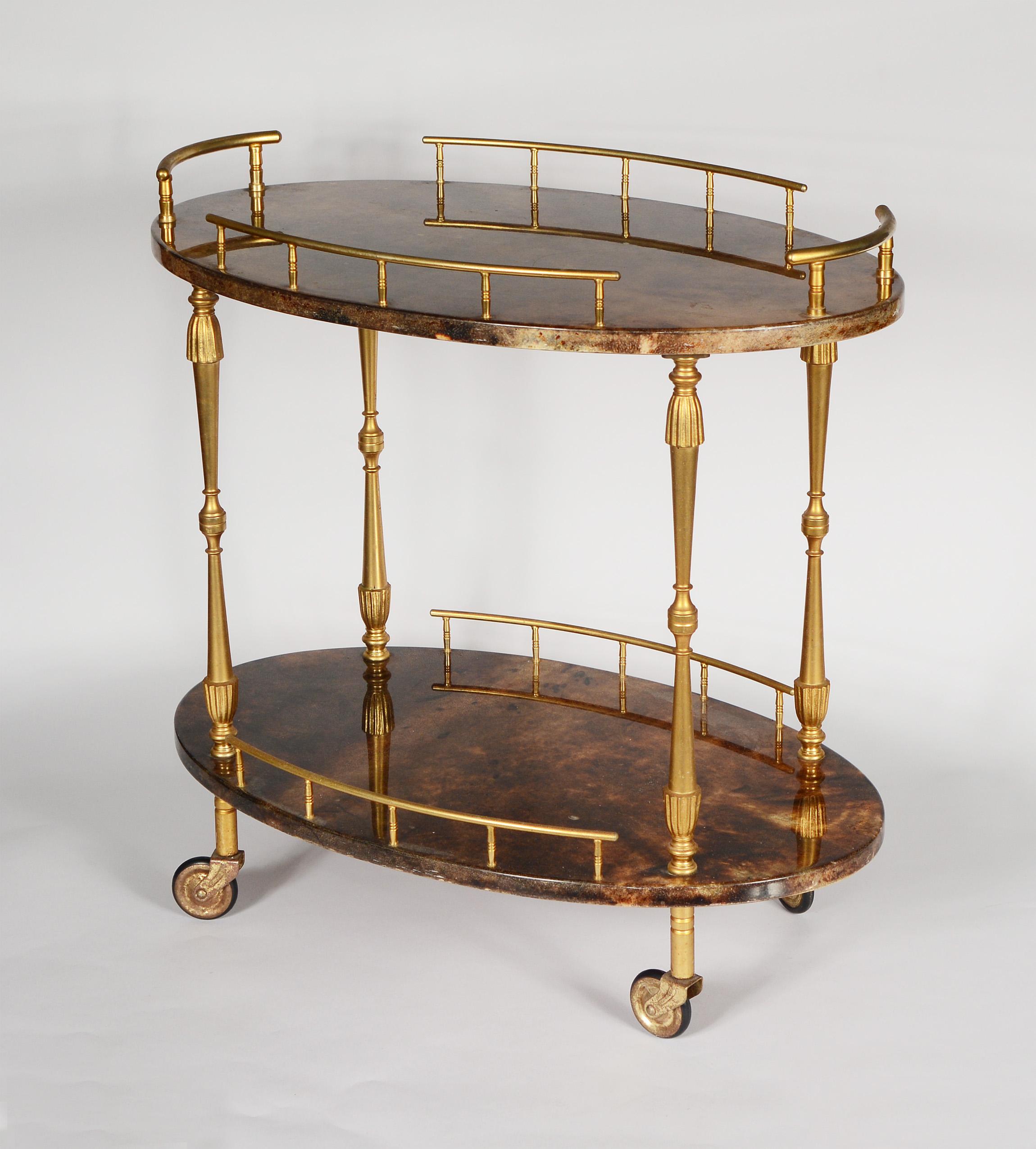 Aldo Tura bar cart with goatskin parchment and gold washed brass. This smaller size cart still has plenty of surface area for barware or decanters. This retains the label. There are a few dings to the resin on the parchment.