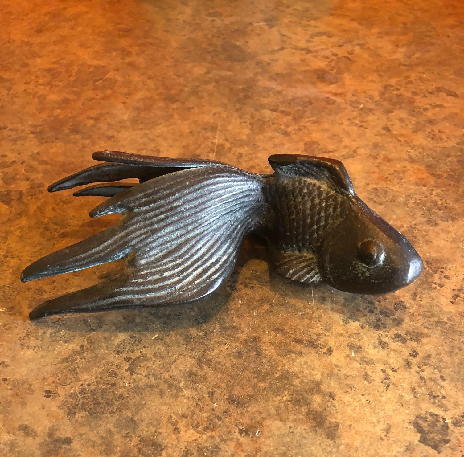Small patinated bronze koi fish sculpture, circa 1970s. The piece has a great look and patinated finish and would make a great paperweight or decorative piece.