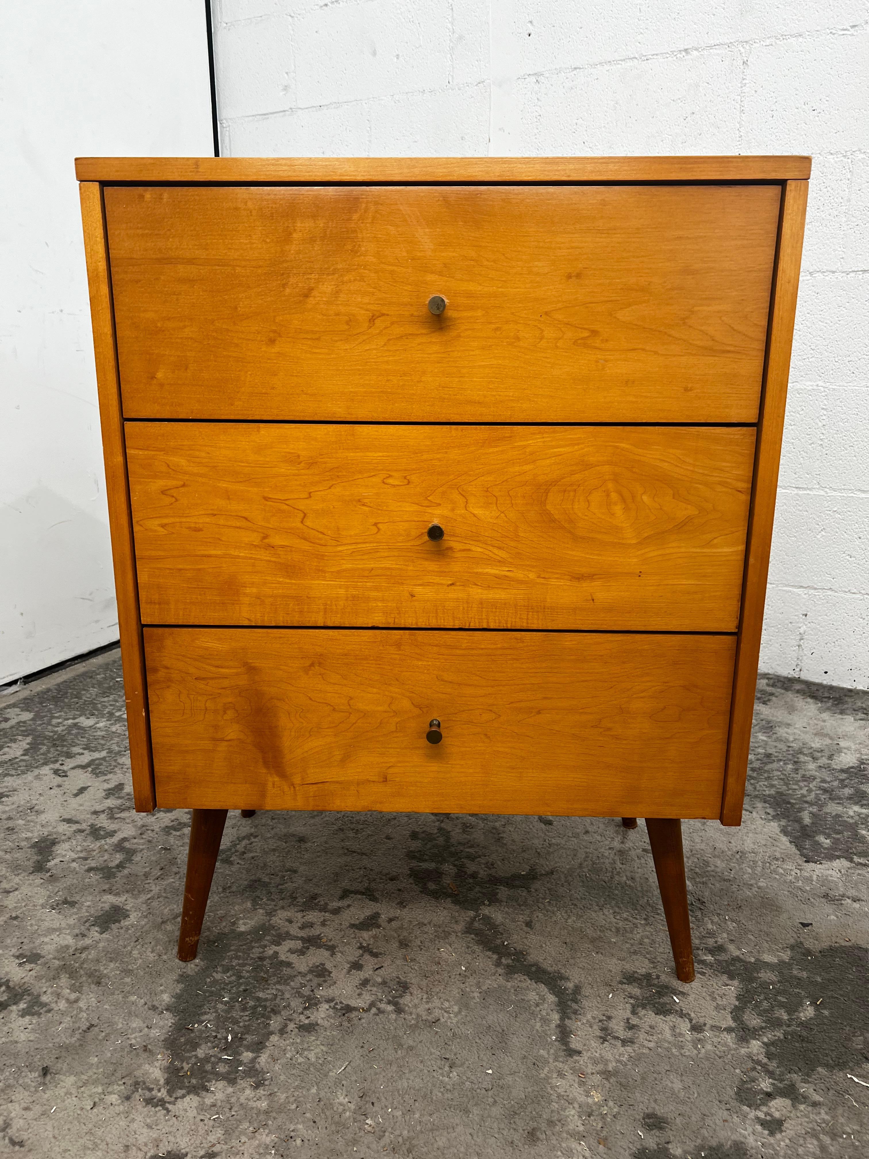 Beautiful Paul McCobb Planner Group three drawer dresser in tobacco maple finish with brass knobs solid maple. In original vintage condition, with no alterations. Very beautiful designed dresser on tapered legs - all solid maple. All legs unscrew.