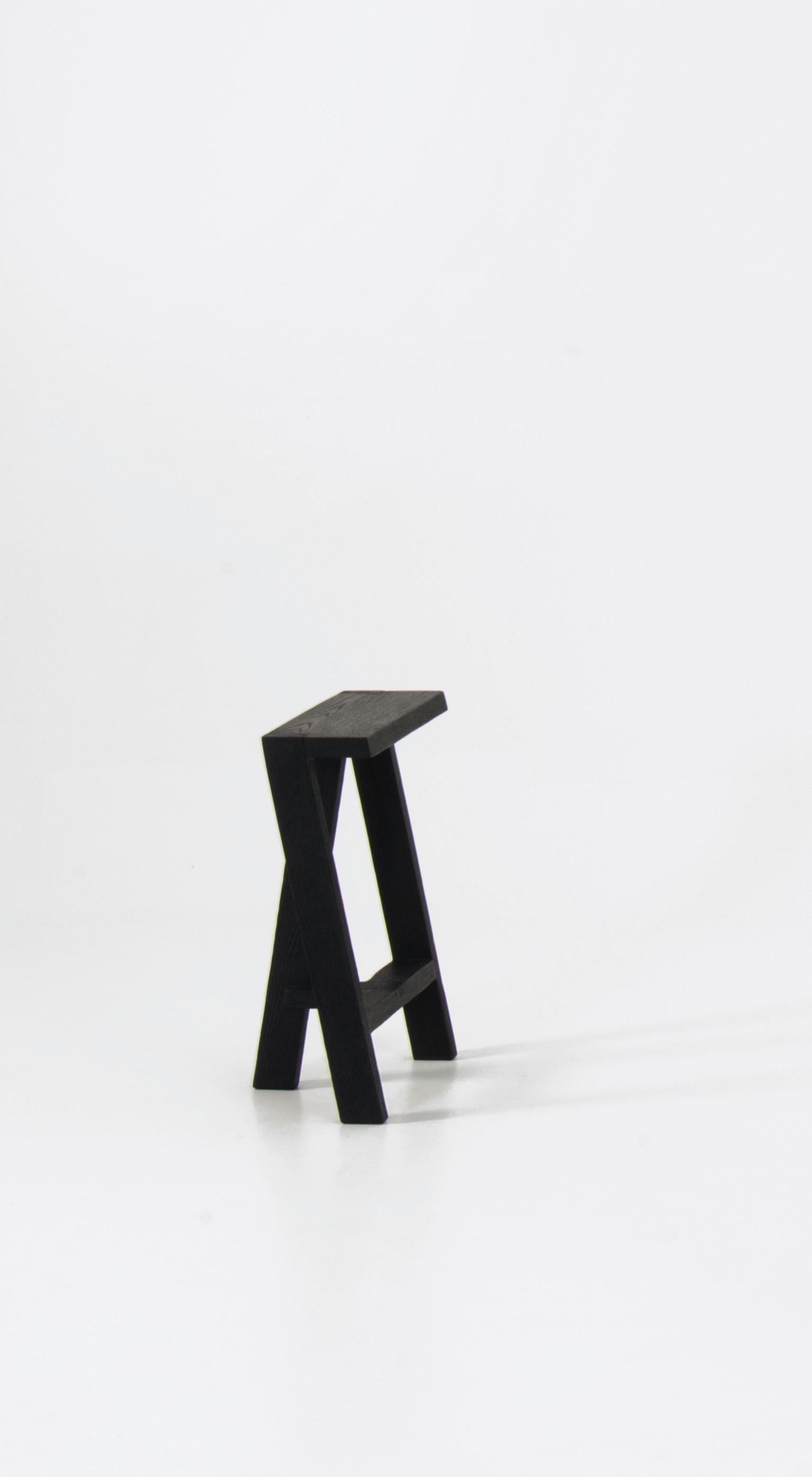 Small Pausa oak stool by Pierre-Emmanuel Vandeputte
Dimensions: D 20 x W 35 x H 45 cm.
Materials: burned oak.
Available in natural oak version and in 3 sizes.

Pausa is a series of stools; 45cm, 65cm, or 80cm of assembled oak pieces. 
The