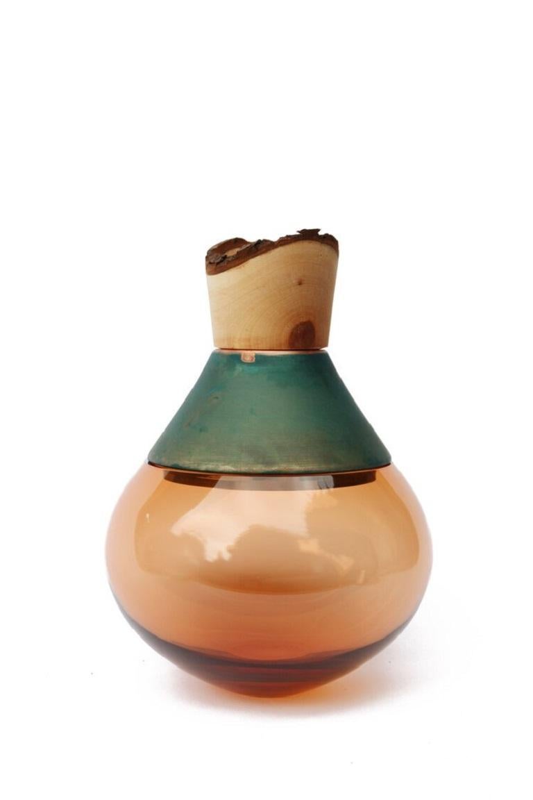 Small peach and copper Patina India Vessel II, Pia Wüstenberg
Dimensions: D 18 x H 25
Materials: glass, wood, copper patina
Available in other metals: brass, copper, copper patina

Handmade in Europe, by individual craftsmen: handblown glass