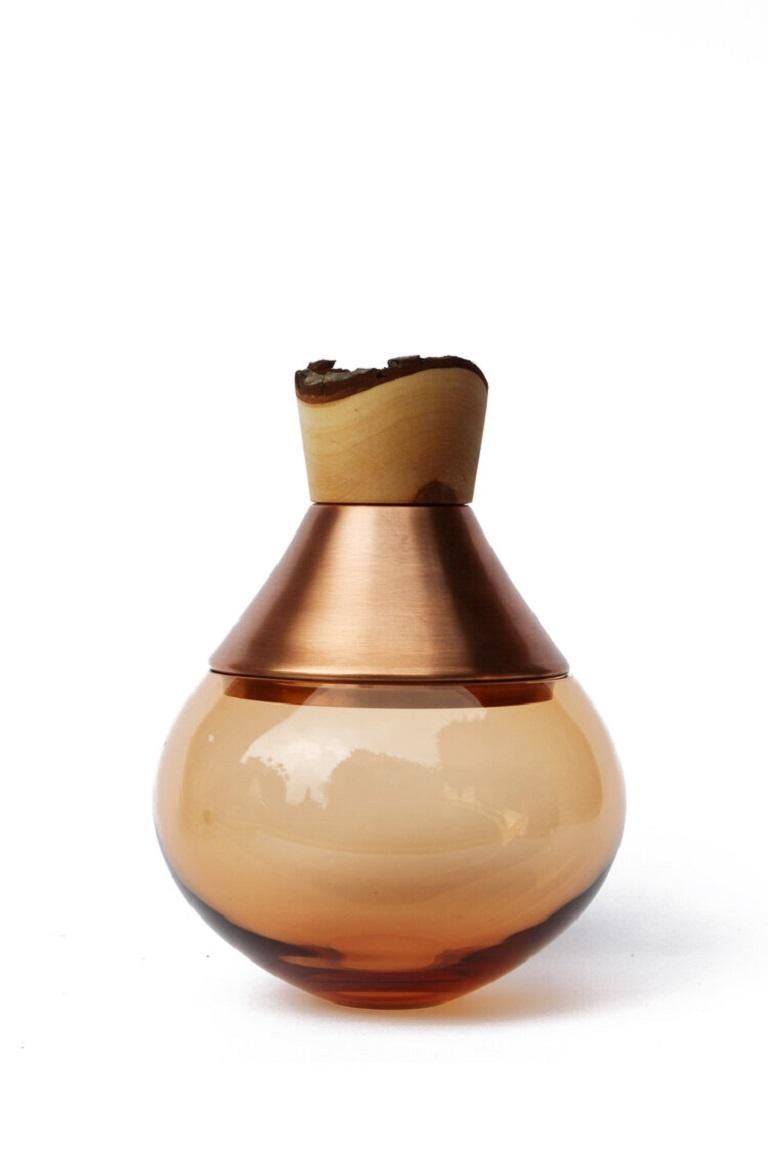 Small Peach India vessel II, Pia Wüstenberg
Dimensions: D 18 x H 25
Materials: glass, wood, metal
Available in other metals: brass, copper, copper patina

Handmade in Europe, by individual craftsmen: handblown glass (Czech Republic), hand spun