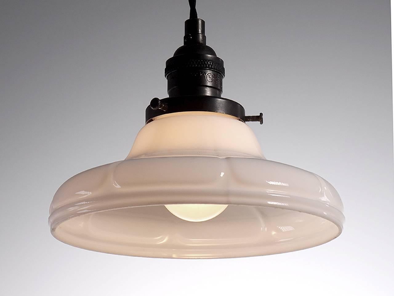 Softly curved bell shaped pendants are a Classic. They feel at home with any style decor. This example has a simple stylized flower pedal design. The pattern is a bit deco and the profile has a straight bottom edge. The lamps are priced per so you
