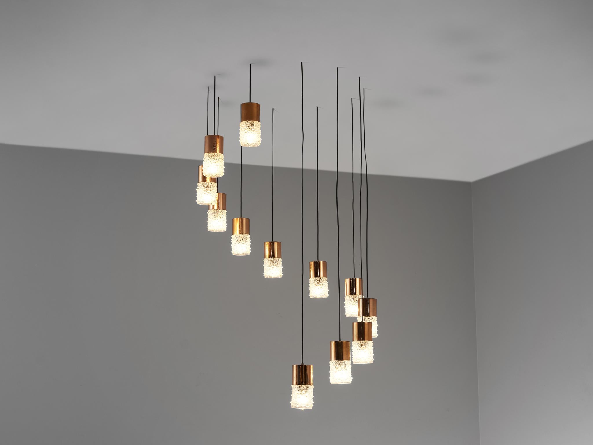 Pendants, copper, glass, Europe, 1960s

This stunning cylindrical pendant features an exquisite lamp shade showing a nice structure of little ‘bubbles’ or raindrops and geometrical lines. This results in a nice and soft light-tone creating an